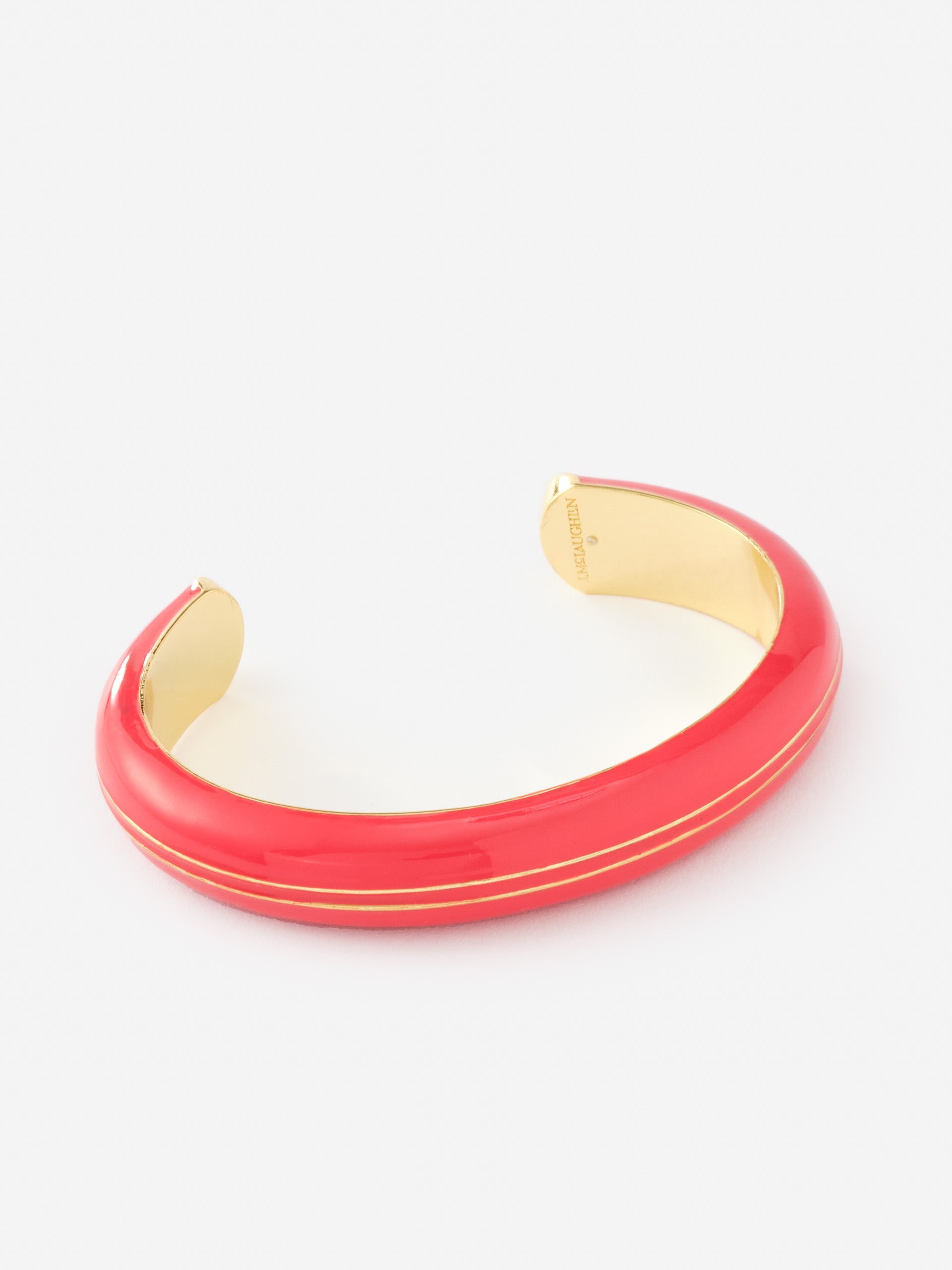 Enamel Striped Cuff by J.McLaughlin features a vibrant red enamel exterior with delicate gold stripes, offering an effortlessly stylish accessory that reflects enduring designs and a legacy of timeless fashion. A destination for defining style. Life, Well-Lived.
