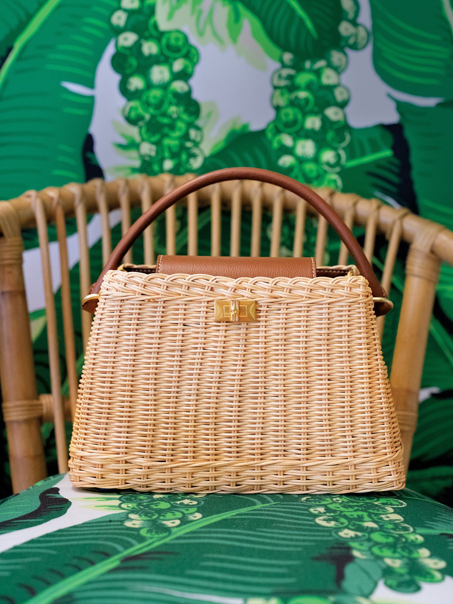 Faith Wicker Handbag by J.McLaughlin featuring a woven wicker design with leather accents, effortlessly stylish and embodying enduring designs in bags for a life well-lived.