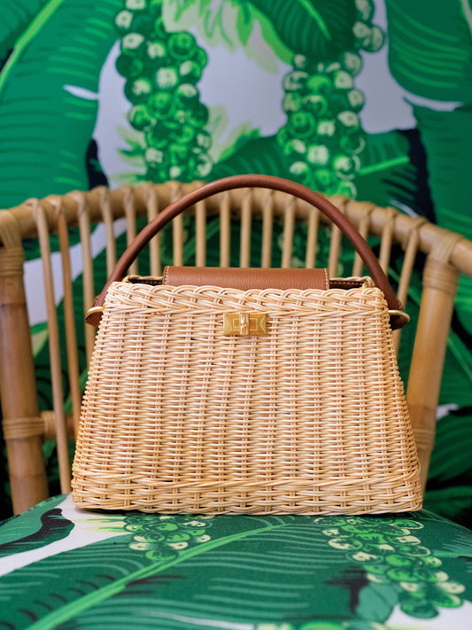 Faith Wicker Handbag by J.McLaughlin featuring a woven wicker design with leather accents, effortlessly stylish and embodying enduring designs in bags for a life well-lived.