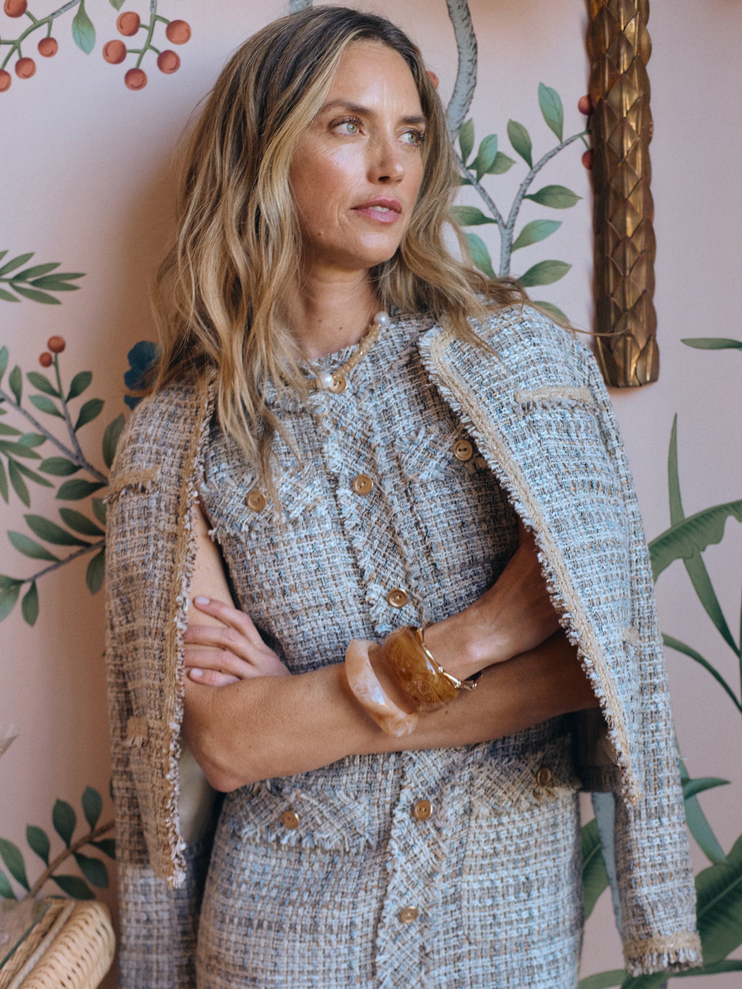 Woman wearing the Martha Tweed Jacket by J.McLaughlin, showcasing effortlessly stylish and enduring designs with innovative fabrics in a timeless, classic setting.