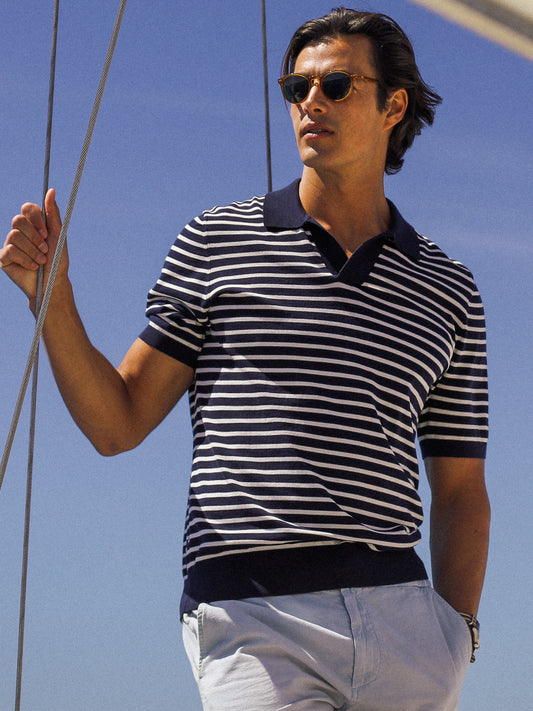 Model wearing J.McLaughlin Cillian sweater polo in navy/egret white made with cotton.