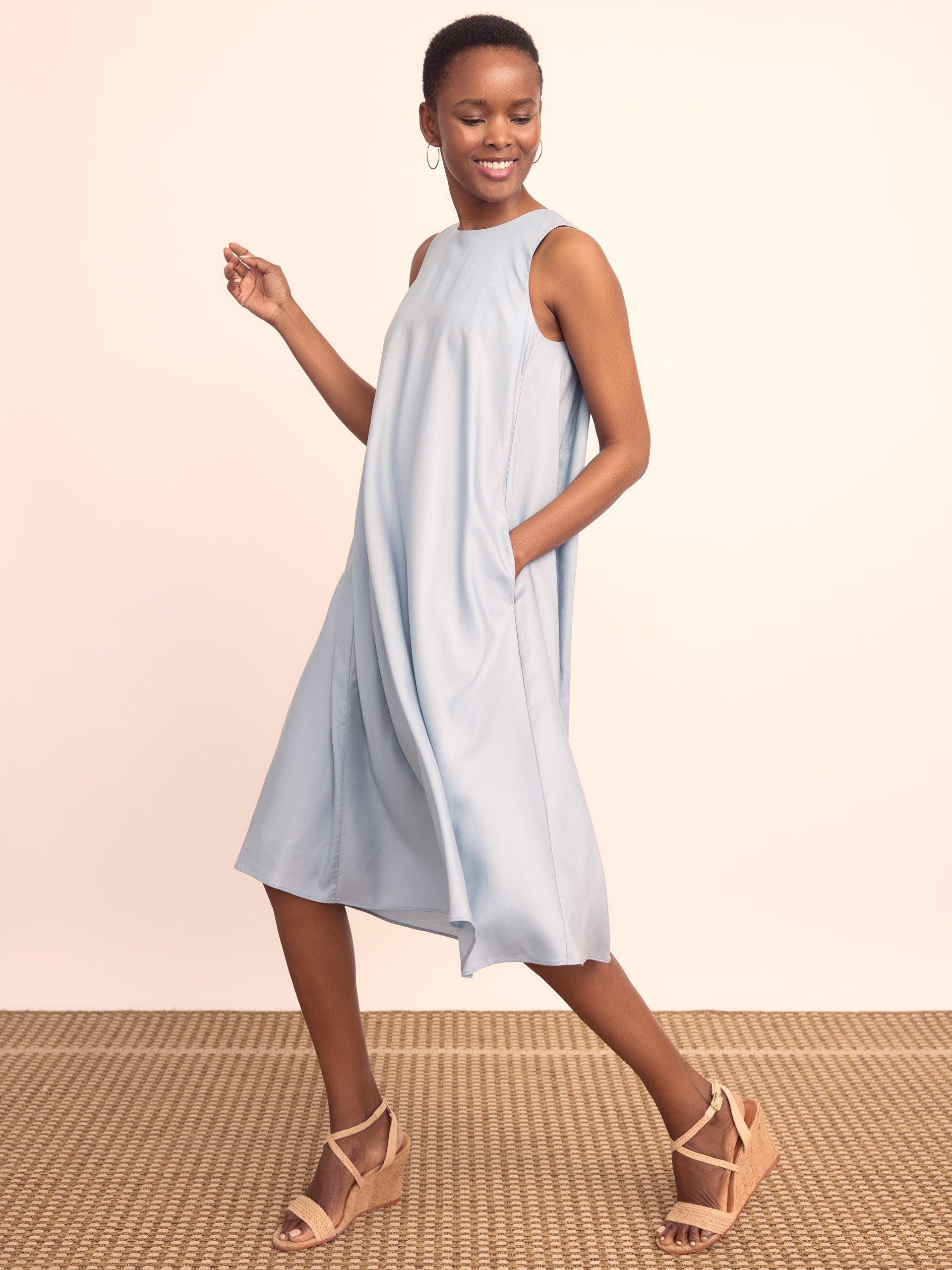 Model wearing J.McLaughlin Anita dress in frost blue made with lyocell.