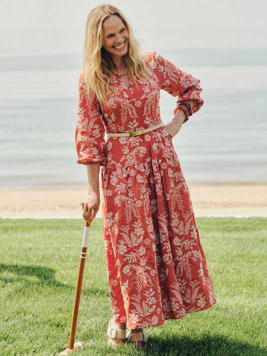 Woman standing on grass near the water wearing the Nancy Linen Blend Embroidered Dress by J.McLaughlin, showcasing effortlessly stylish, enduring designs with innovative fabrics.