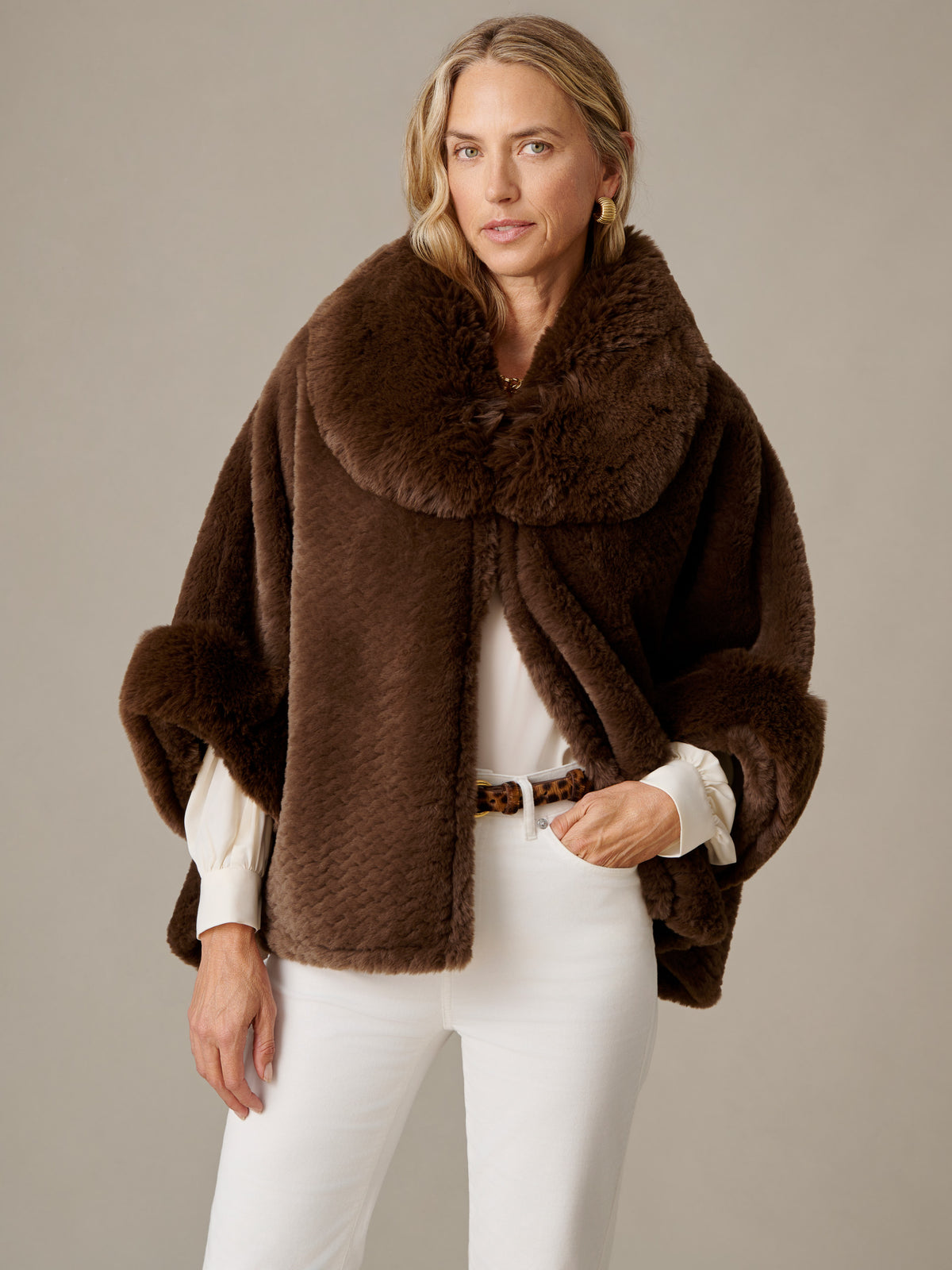 J.McLaughlin Andie Faux Fur Cape in rich brown faux fur styled with white pants and a blouse for a luxe timeless look