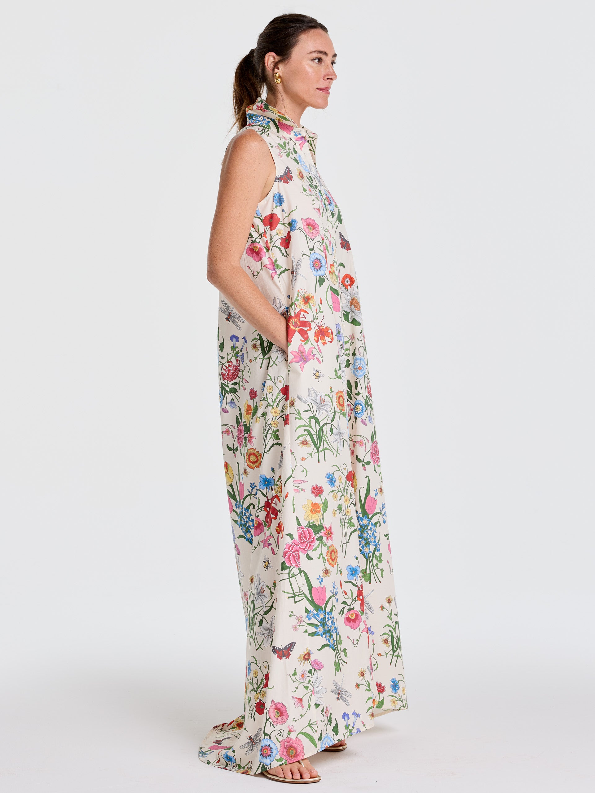 A woman models the Audrey Dress in Dragonfly Garden by J.McLaughlin, featuring a flowing silhouette with floral and dragonfly patterns, effortlessly stylish and enduring designs, perfect for a life well-lived.