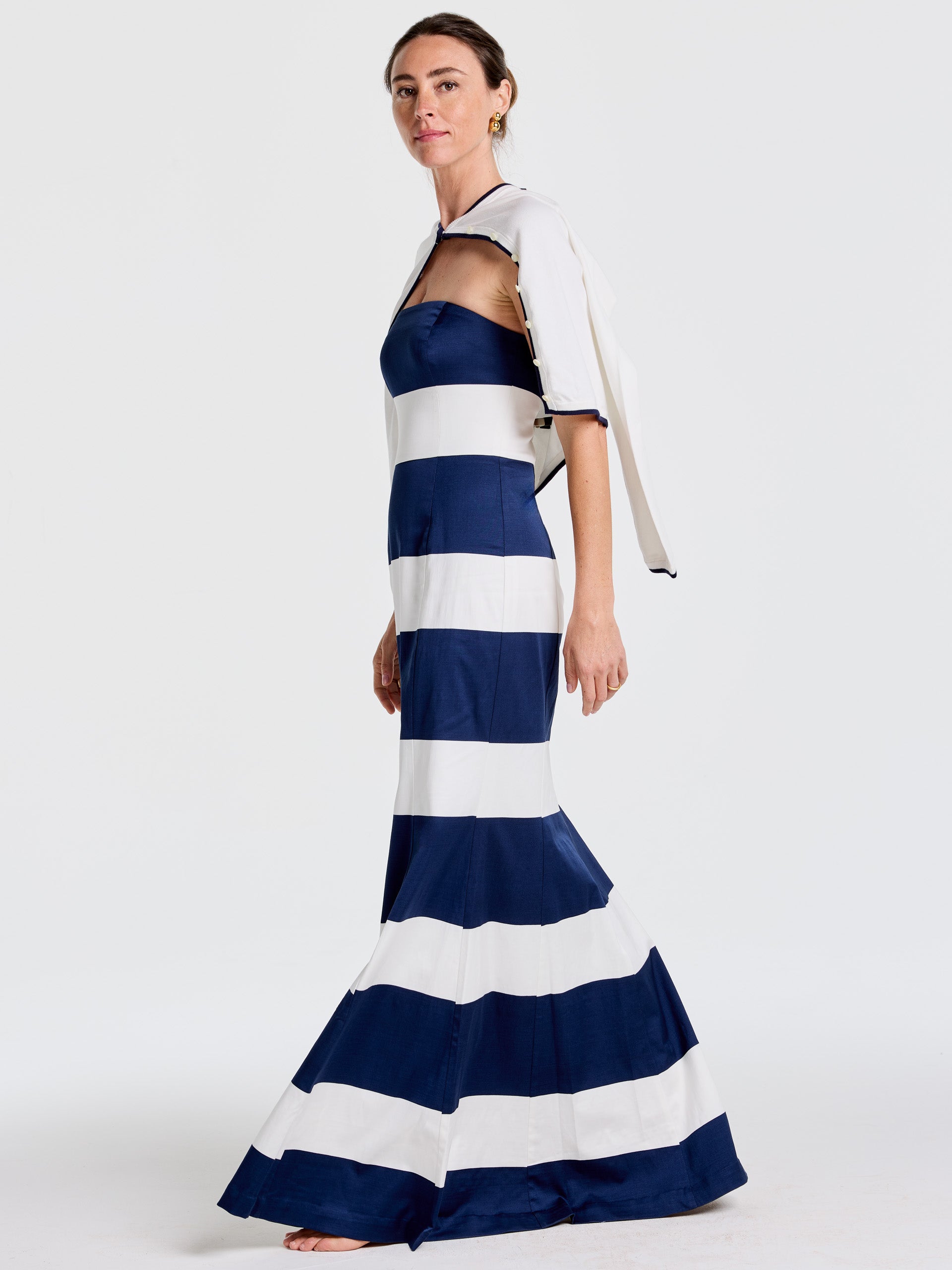 Woman modeling the Ashley Dress in Mega Mariner Stripe by J.McLaughlin, featuring bold navy and white stripes, embodying effortlessly stylish, enduring designs with a legacy of timeless fashion. A destination for defining style. Life, Well-Lived.