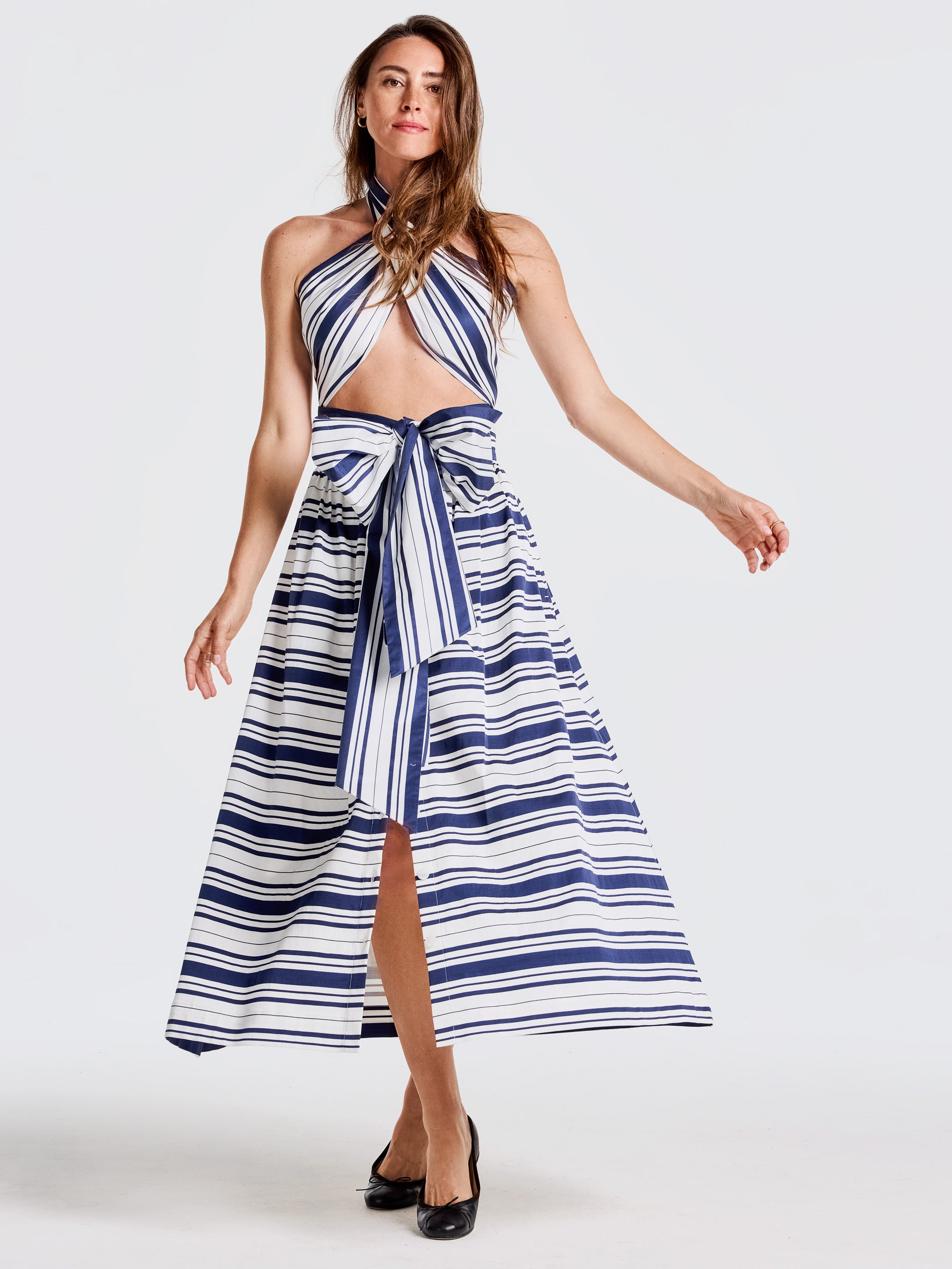 Woman wearing a Susie Skirt in Mariner Stripe by J.McLaughlin paired with a matching halter top, showcasing effortlessly stylish, enduring designs in classic stripes.