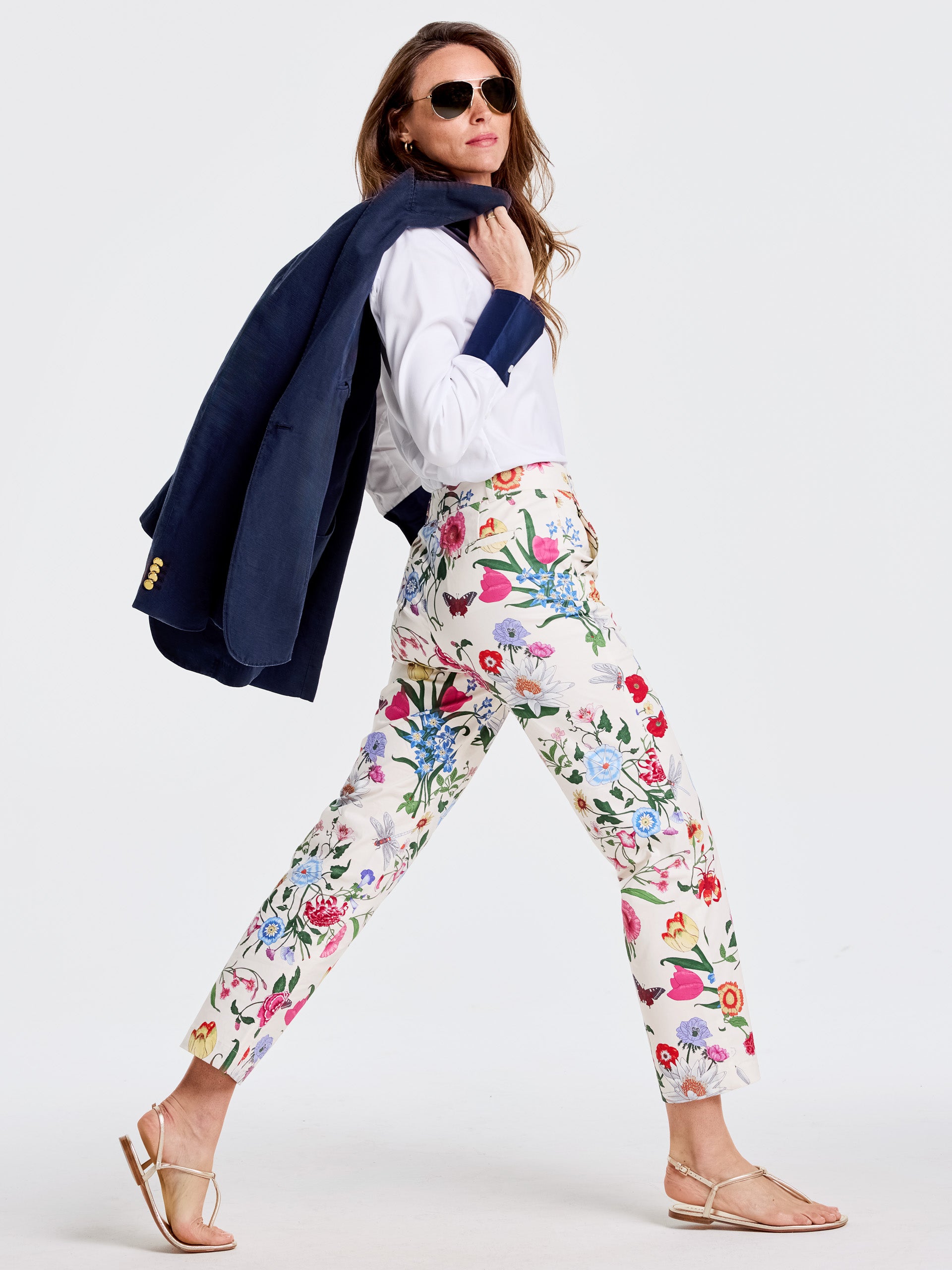 Woman wearing Avery Pants in Dragonfly Garden with floral print paired with a white blouse and navy blazer, showcasing J.McLaughlin’s effortlessly stylish, enduring designs.