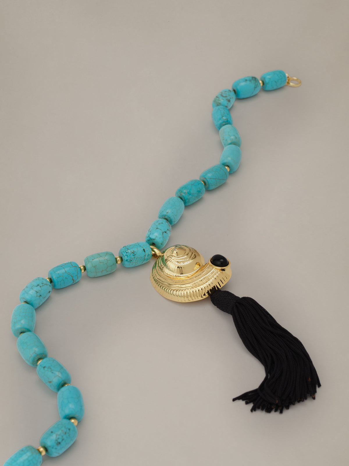 Shell Tassel Necklace by J.McLaughlin with turquoise beads gold shell pendant and dramatic black tassel for a coastal statement look