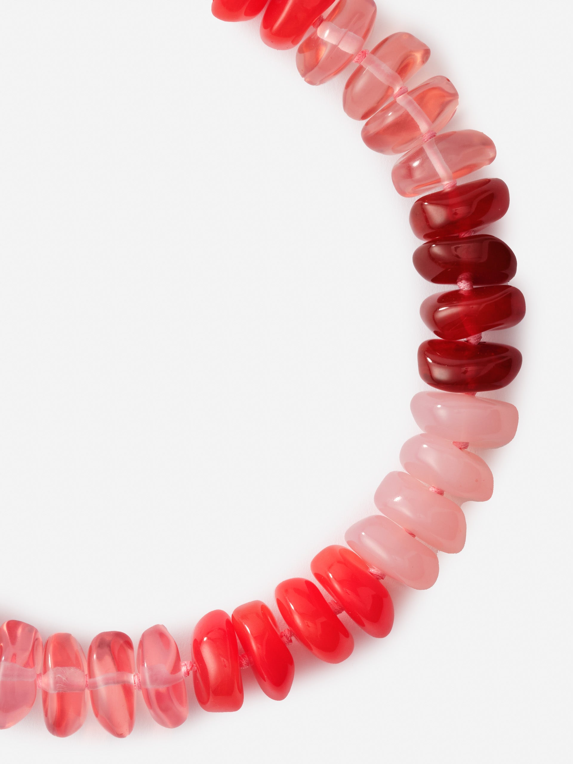 Close-up of the Tonal Bead Necklace by J.McLaughlin featuring a smooth gradient of red and pink beads, showcasing effortlessly stylish, enduring designs and a legacy of timeless fashion.