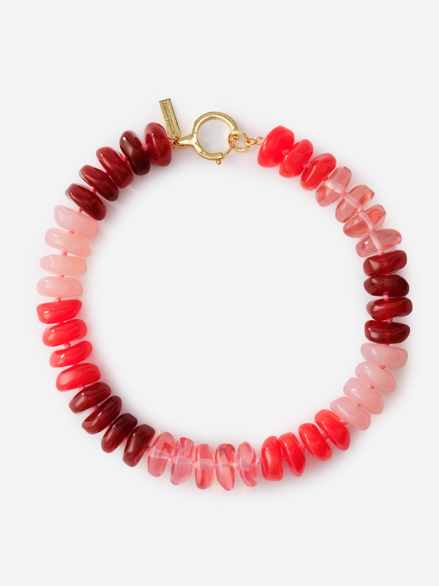Tonal Bead Necklace by J.McLaughlin features a mix of red and pink beads with a gold clasp, exemplifying effortlessly stylish, enduring designs for a legacy of timeless fashion.