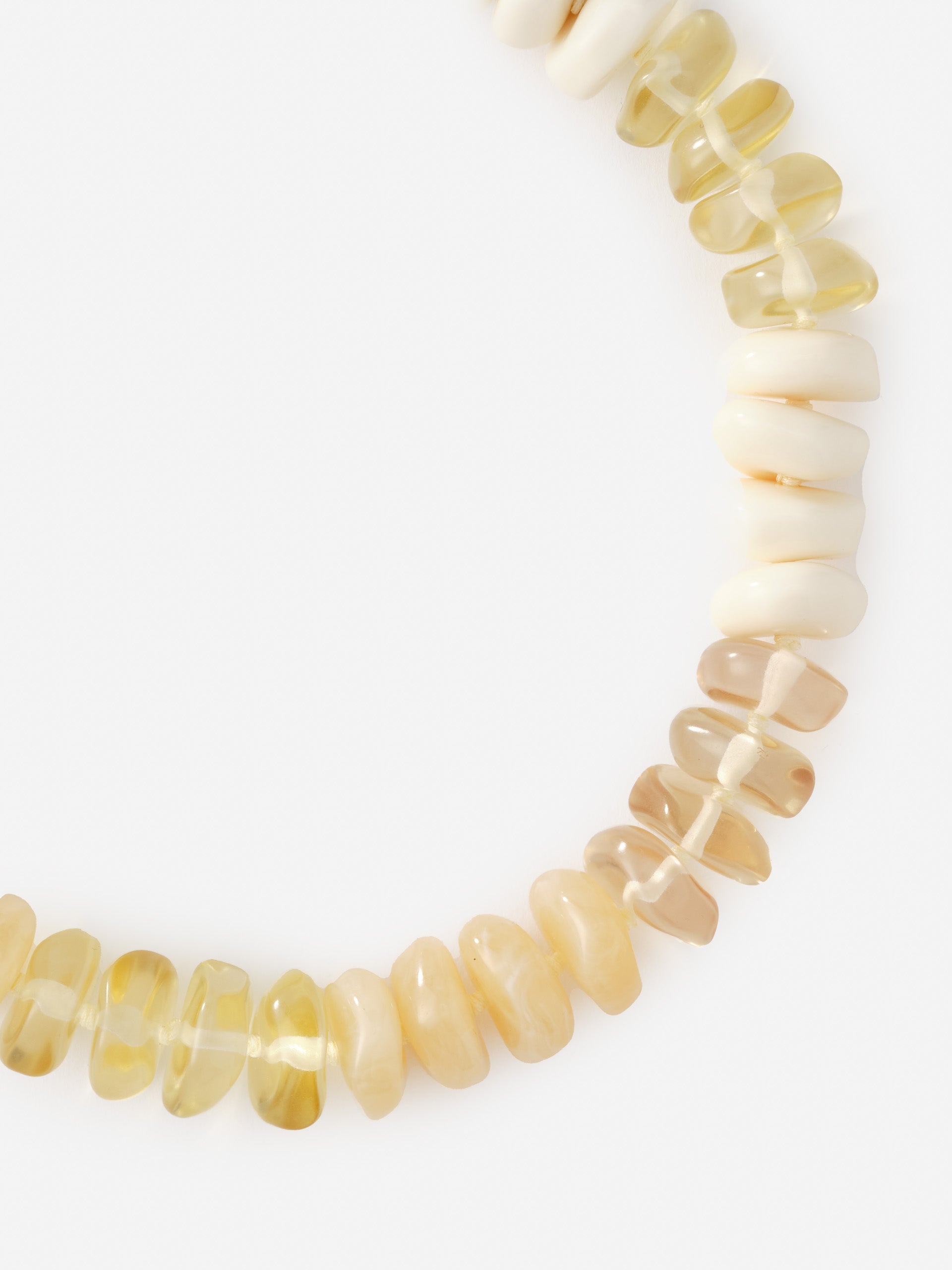 Close-up of a Tonal Bead Necklace by J.McLaughlin featuring smooth, irregular beads in warm neutral tones, reflecting effortlessly stylish, enduring designs and a legacy of timeless fashion.