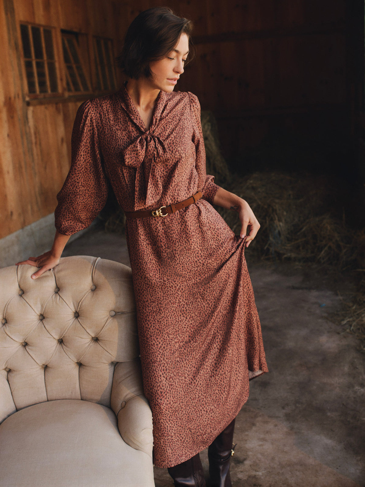 J.McLaughlin Cally Silk Blend Dress in Leopardette shown on a woman with long sleeves and a tied scarf neckline in a timeless leopard print style