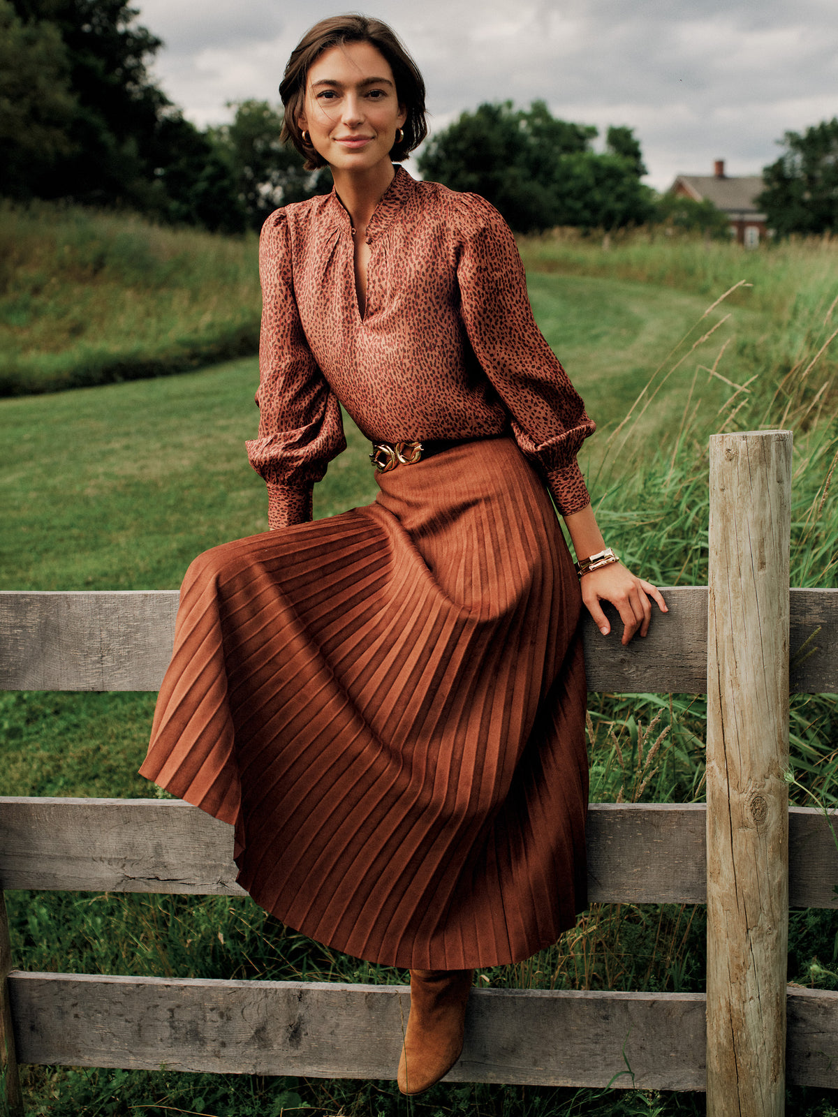 J.McLaughlin Ellery Faux Suede Skirt in rich brown faux suede with graceful pleats and a flowing midi silhouette styled for timeless elegance outdoors