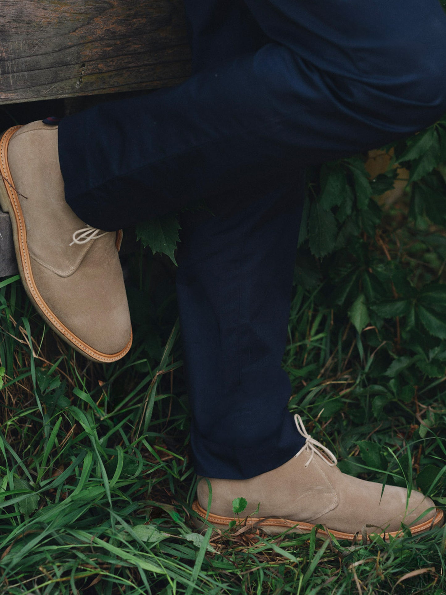Davis Suede Desert Boots by J.McLaughlin in tan suede worn with navy trousers outdoors for an effortlessly stylish look and lasting appeal