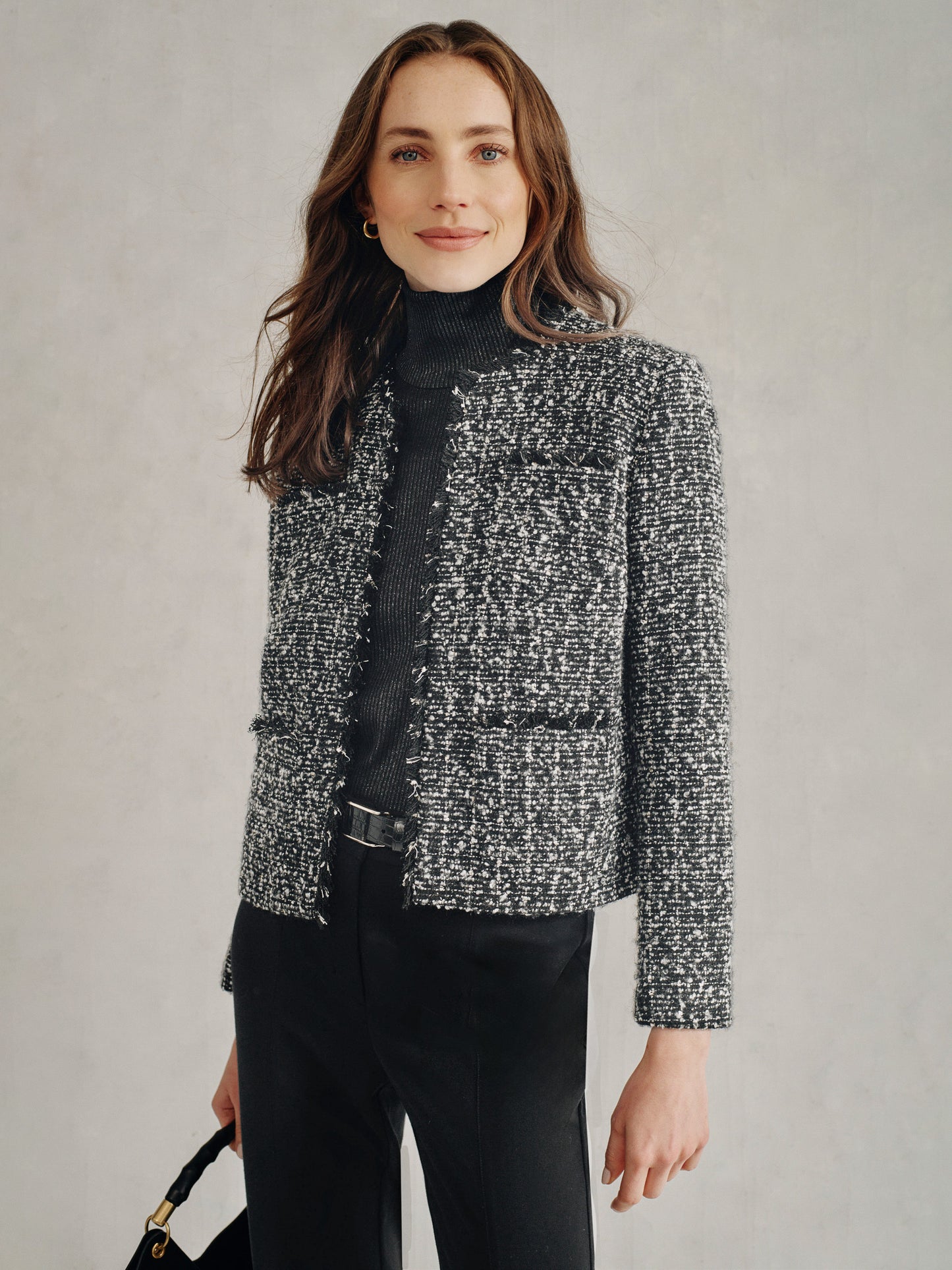 Model wearing J.McLaughlin Martha jacket in black/grey made with tweed.