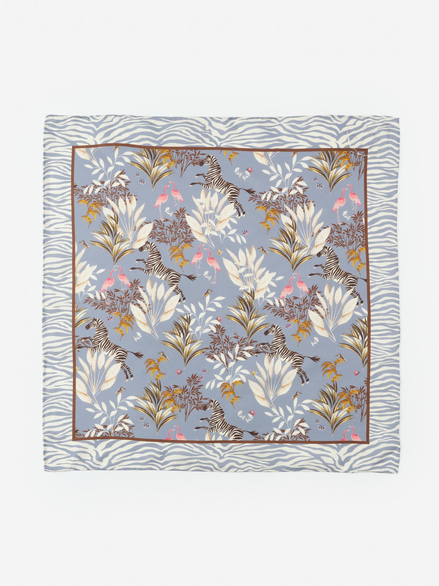Nikka Silk Scarf in Zebra Story Court by J.McLaughlin features an effortlessly stylish design with zebras and tropical foliage on a soft blue background, embodying enduring designs and a legacy of timeless fashion. A destination for defining style. Life, Well-Lived.