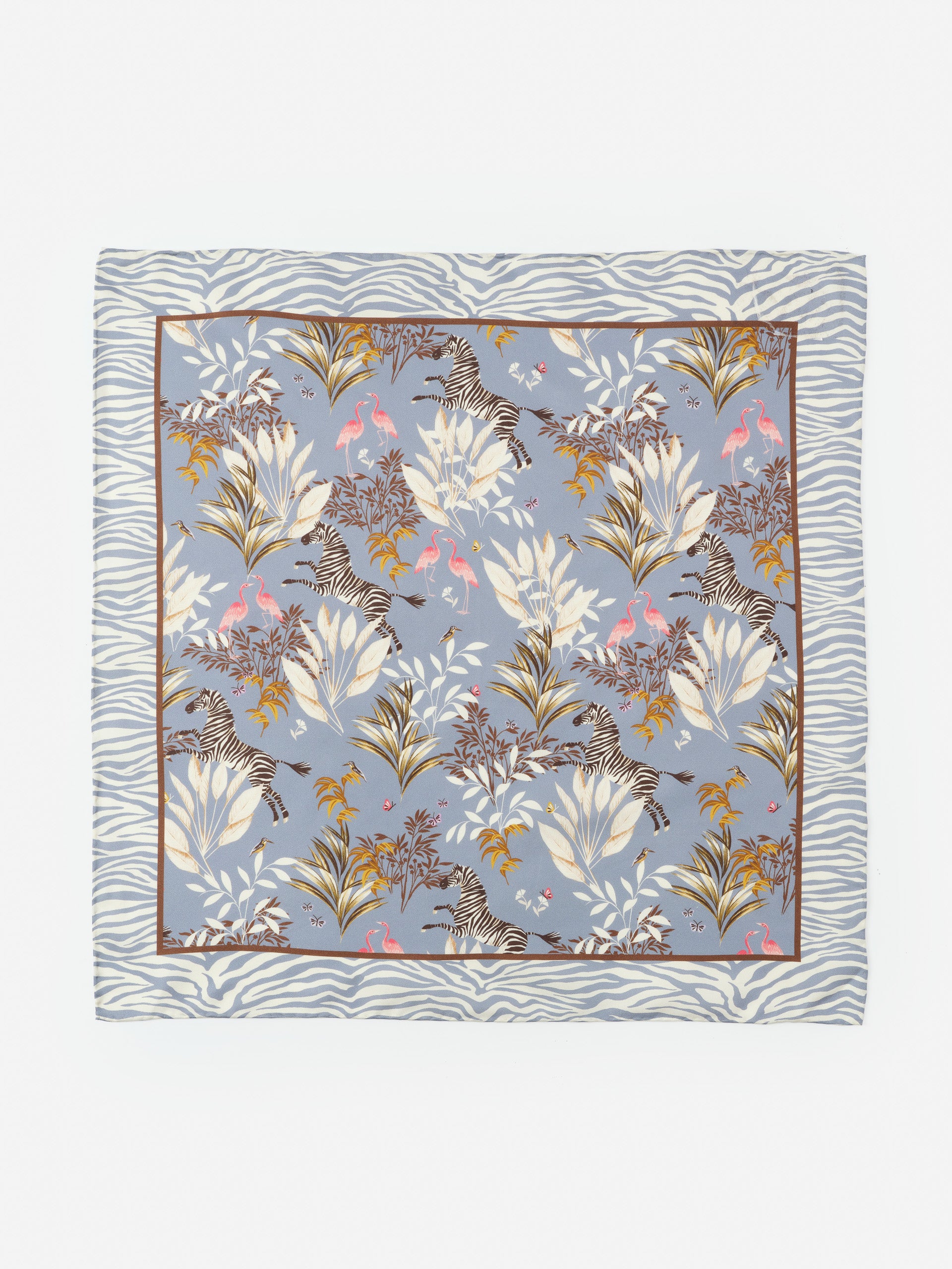 Nikka Silk Scarf in Zebra Story Court by J.McLaughlin features an effortlessly stylish design with zebras and tropical foliage on a soft blue background, embodying enduring designs and a legacy of timeless fashion. A destination for defining style. Life, Well-Lived.