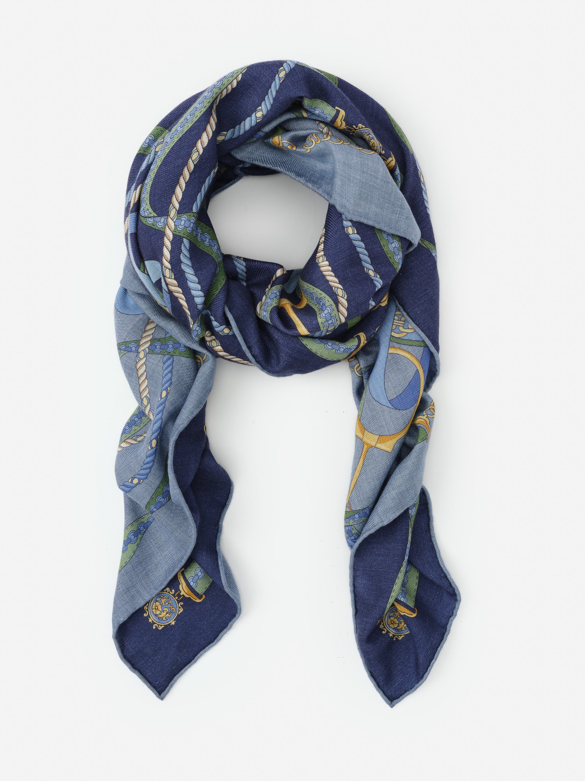 Vanessa Scarf in Nouveau Middleburg Border by J.McLaughlin features a thoughtfully designed, effortlessly stylish scarf in blue tones with intricate rope and chain patterns, blending innovative fabrics and enduring designs for a legacy of timeless fashion. A destination for defining style. Life, Well-Lived.