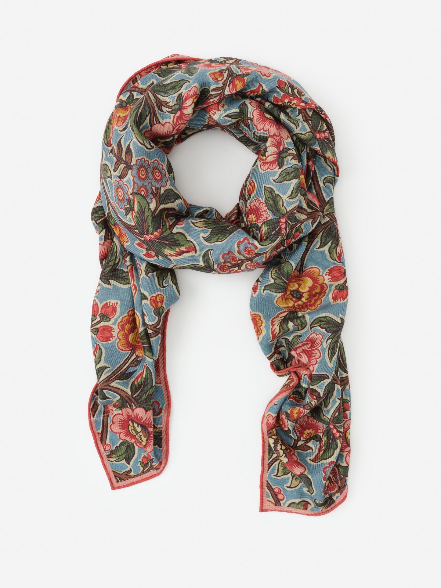 Vanessa Scarf in Bucolic Blooms Border by J.McLaughlin features an effortlessly stylish floral pattern in warm tones on soft fabric, embodying enduring designs and a legacy of timeless fashion. A destination for defining style. Life, Well-Lived.