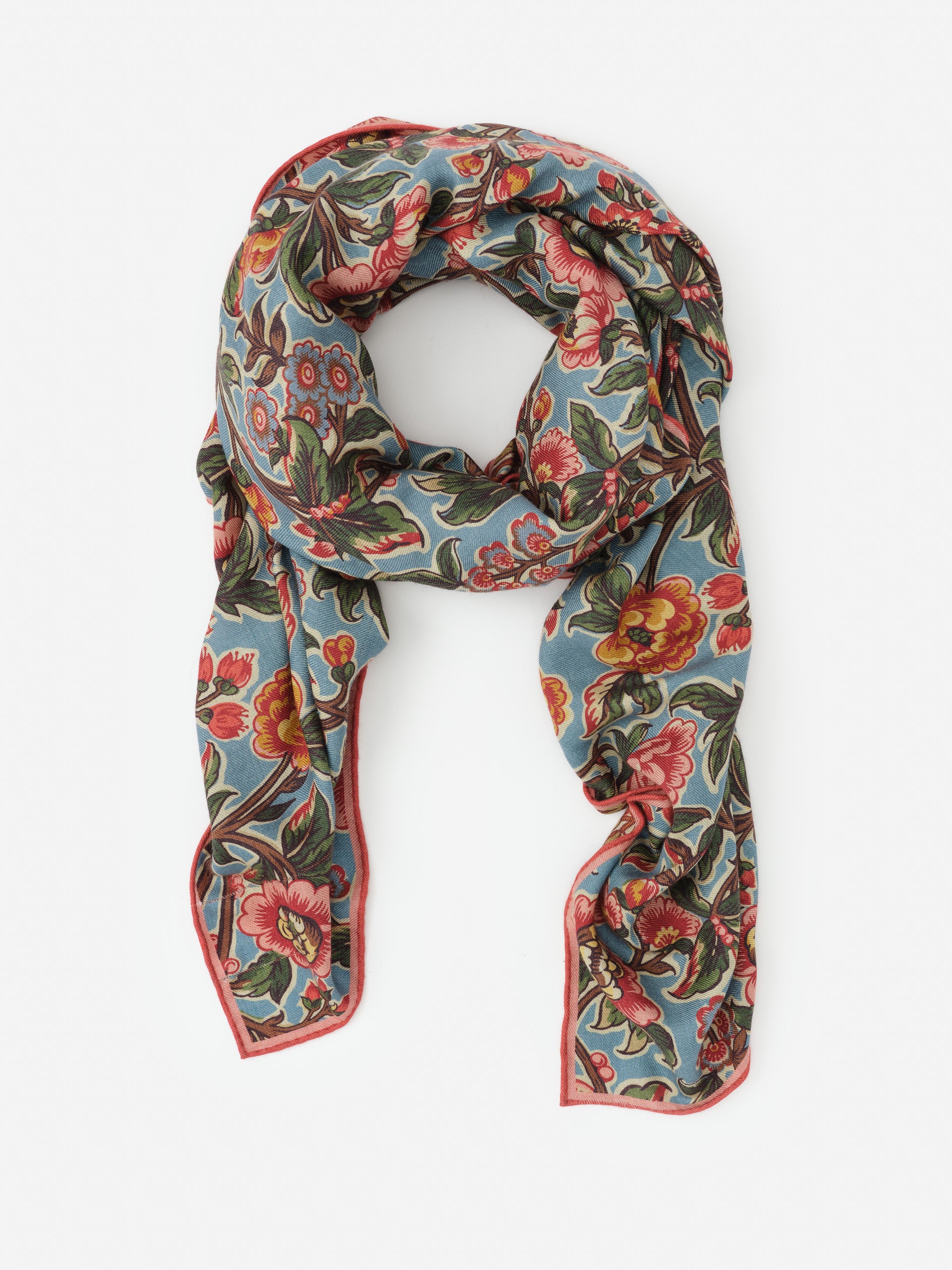 Vanessa Scarf in Bucolic Blooms Border by J.McLaughlin features an effortlessly stylish floral pattern in warm tones on soft fabric, embodying enduring designs and a legacy of timeless fashion. A destination for defining style. Life, Well-Lived.