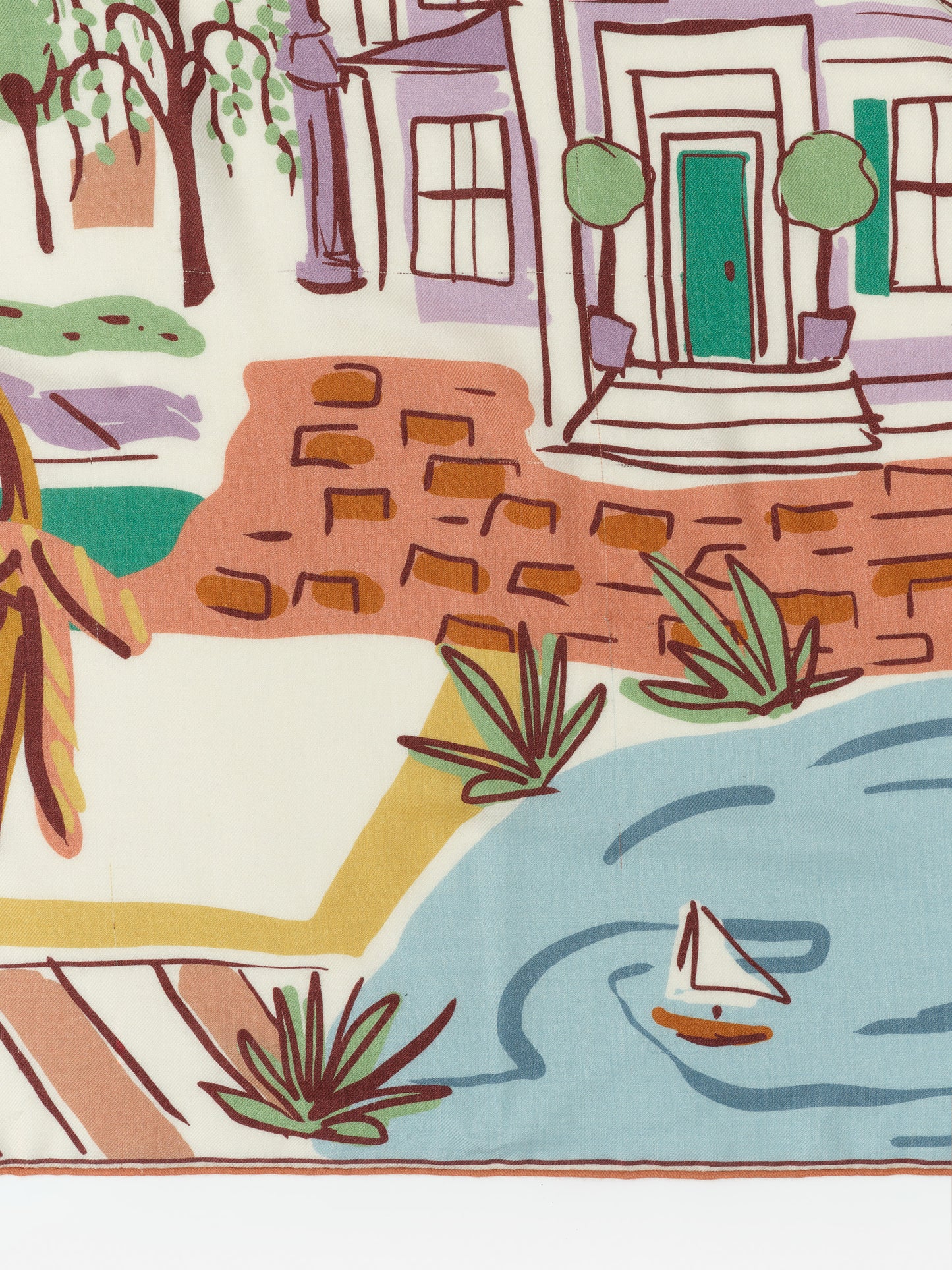 Close-up detail of the Vanessa Scarf in Village Stroll Border by J.McLaughlin, featuring a colorful, artistic print of a charming neighborhood scene, embodying effortlessly stylish and enduring designs.