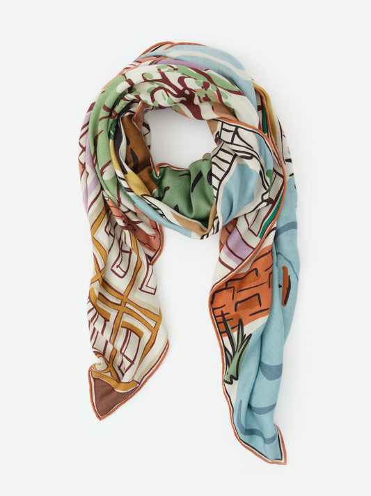 Lightweight scarf with an artistic multicolor pattern in green, blue, orange, and cream tones, showcasing J.McLaughlin’s Vanessa Scarf in Village Stroll Border, effortlessly stylish for enduring designs and a legacy of timeless fashion. A destination for defining style. Life, Well-Lived.