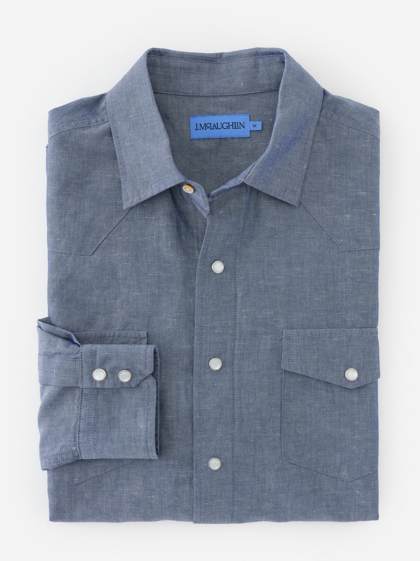 Folded Tribeca Western Shirt by J.McLaughlin in a soft blue fabric, showcasing effortlessly stylish, enduring designs and innovative fabrics for a legacy of timeless fashion. A destination for defining style. Life, Well-Lived.