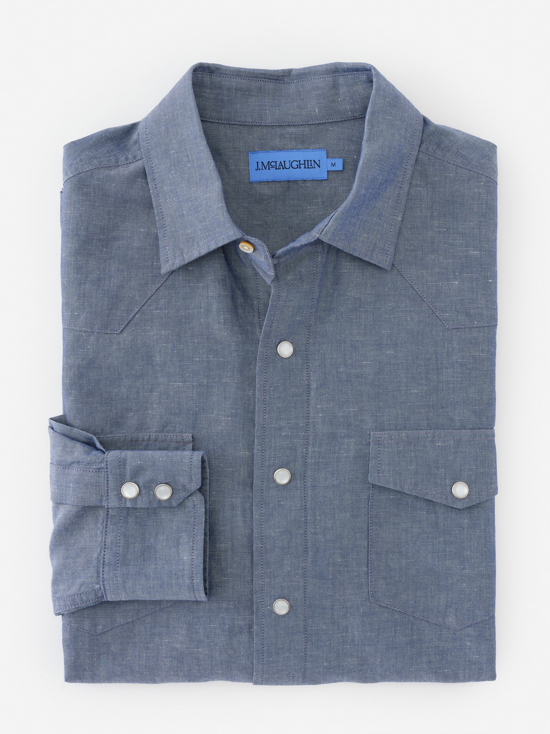 Folded Tribeca Western Shirt by J.McLaughlin in a soft blue fabric, showcasing effortlessly stylish, enduring designs and innovative fabrics for a legacy of timeless fashion. A destination for defining style. Life, Well-Lived.
