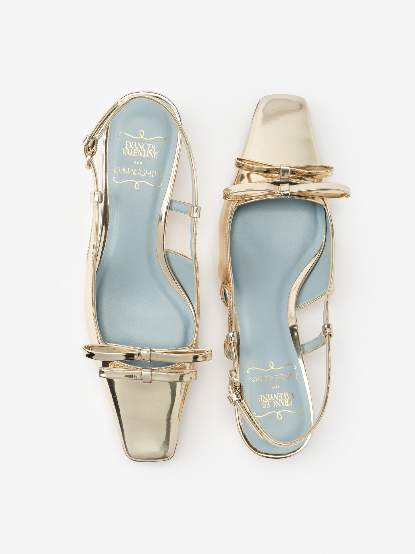 Emma Block Heels by J. McLaughlin feature a metallic finish with a modern square toe and delicate straps, showcasing effortlessly stylish, enduring designs and innovative fabrics.