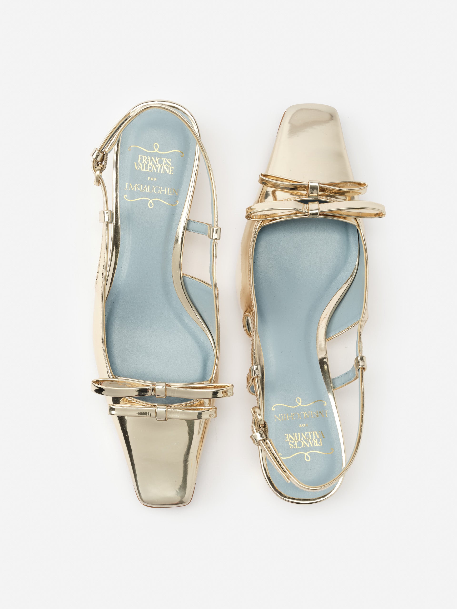 Emma Block Heels by J. McLaughlin feature a metallic finish with a modern square toe and delicate straps, showcasing effortlessly stylish, enduring designs and innovative fabrics.
