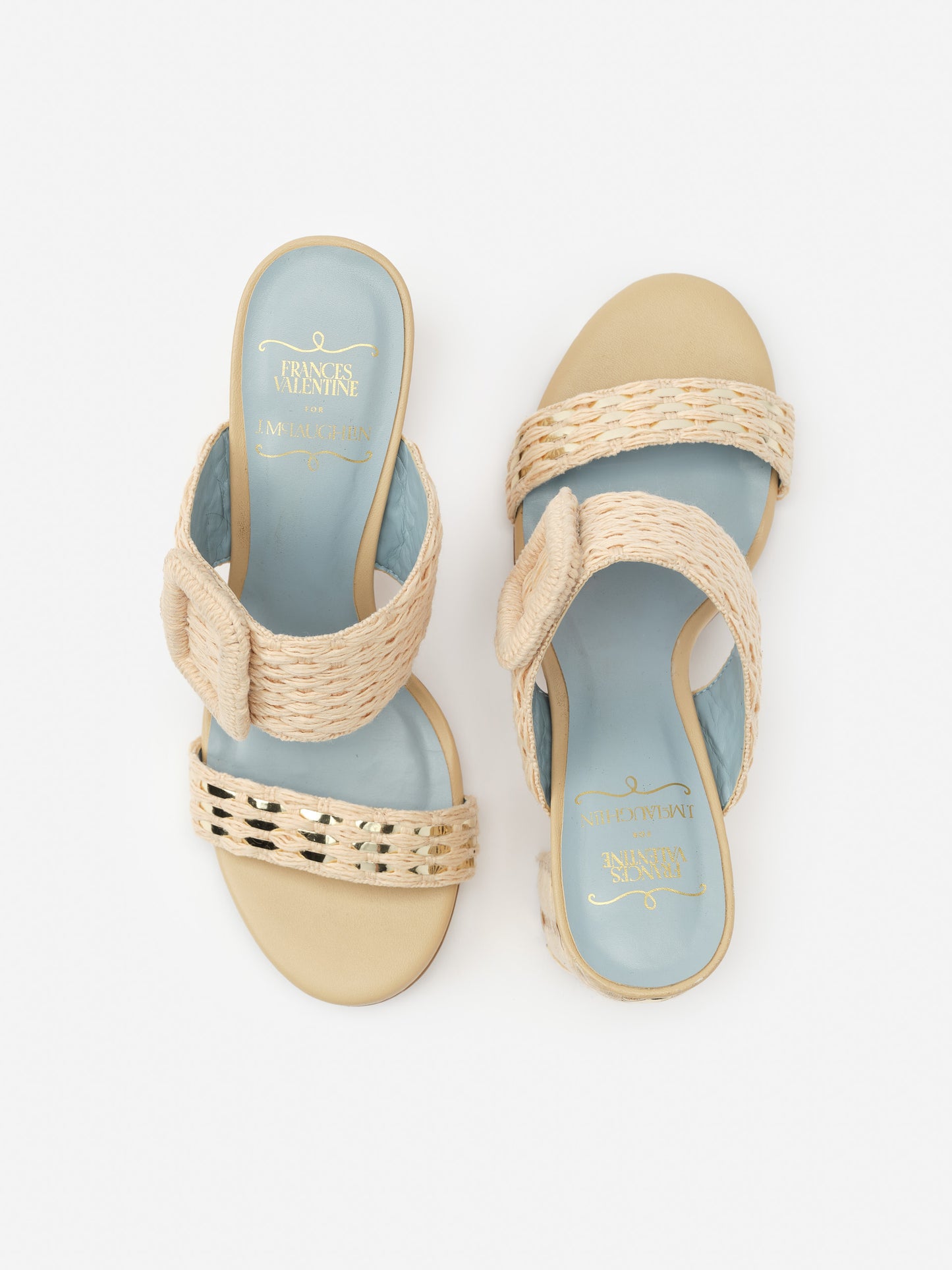 A pair of Betty Heels by J.McLaughlin featuring woven beige straps with a light blue footbed, combining effortlessly stylish design and enduring appeal for a life well-lived.