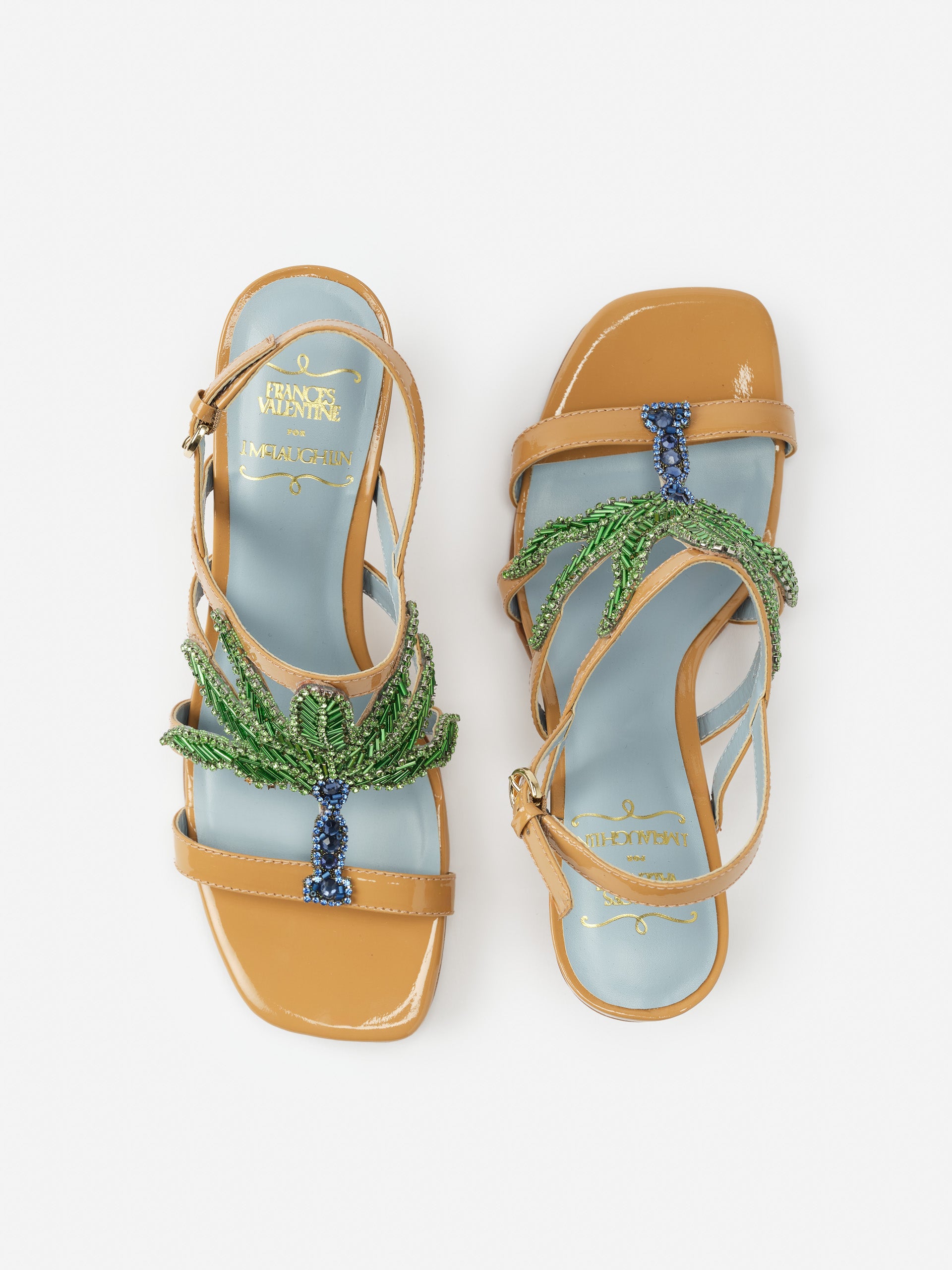 Venus Palm Tree Heels by J.McLaughlin featuring tan leather straps and intricate green and blue beaded palm tree embellishments on a light blue footbed, effortlessly stylish and enduring designs, innovative fabrics, legacy of timeless fashion, a destination for defining style. Life, Well-Lived.