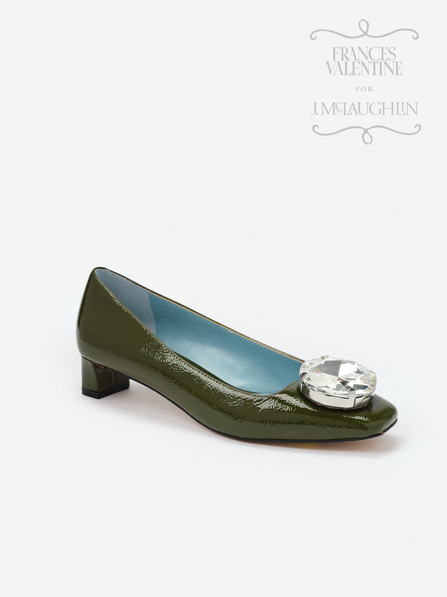 Olive green patent leather Mary Block Heels with a low block heel and large crystal embellishment on the toe, reflecting J.McLaughlin’s legacy of timeless fashion and enduring designs.