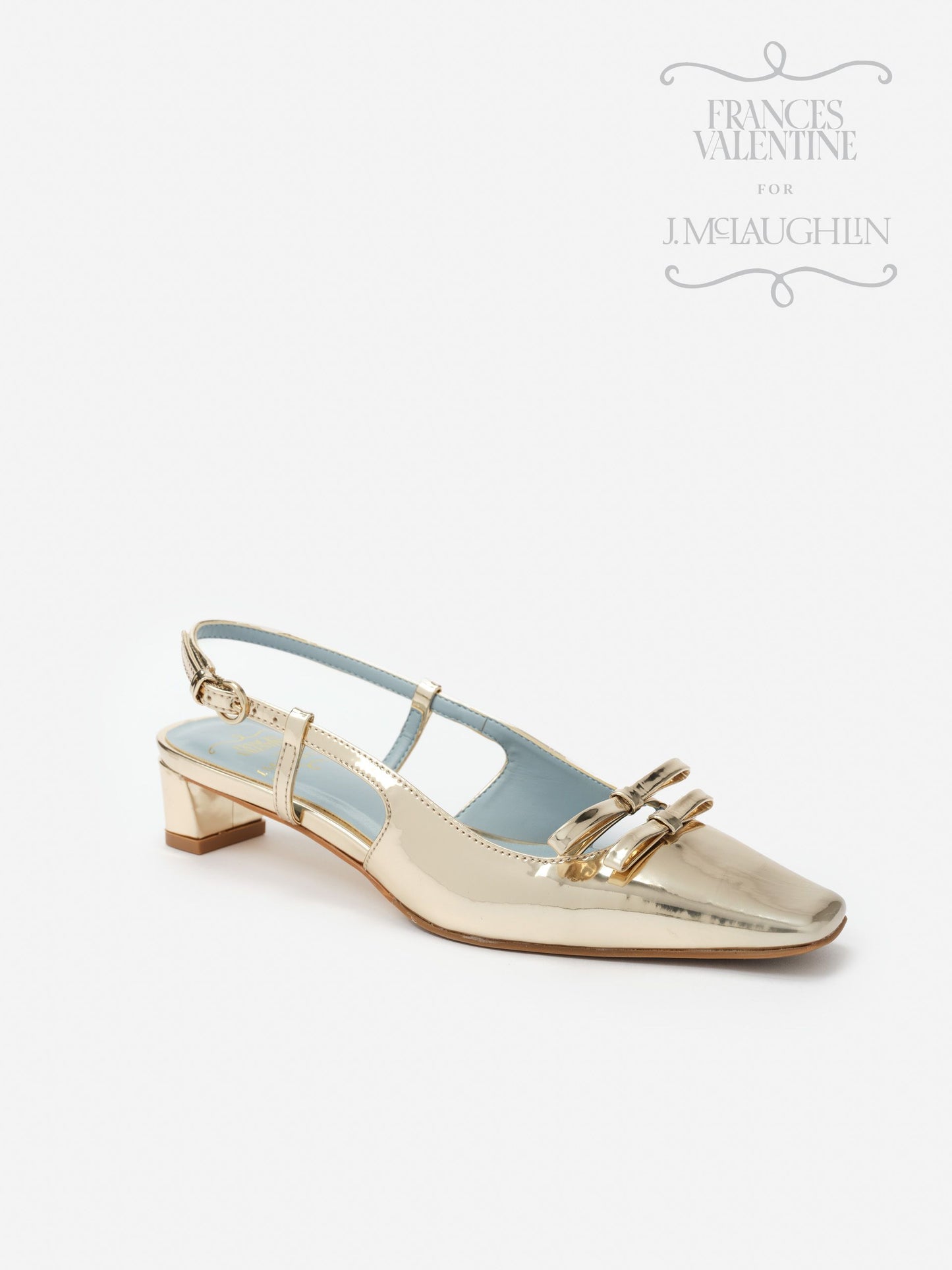 Emma Block Heels by J.McLaughlin showcase effortlessly stylish, metallic gold shoes with a low block heel and elegant buckle detail, embodying enduring designs and a legacy of timeless fashion.