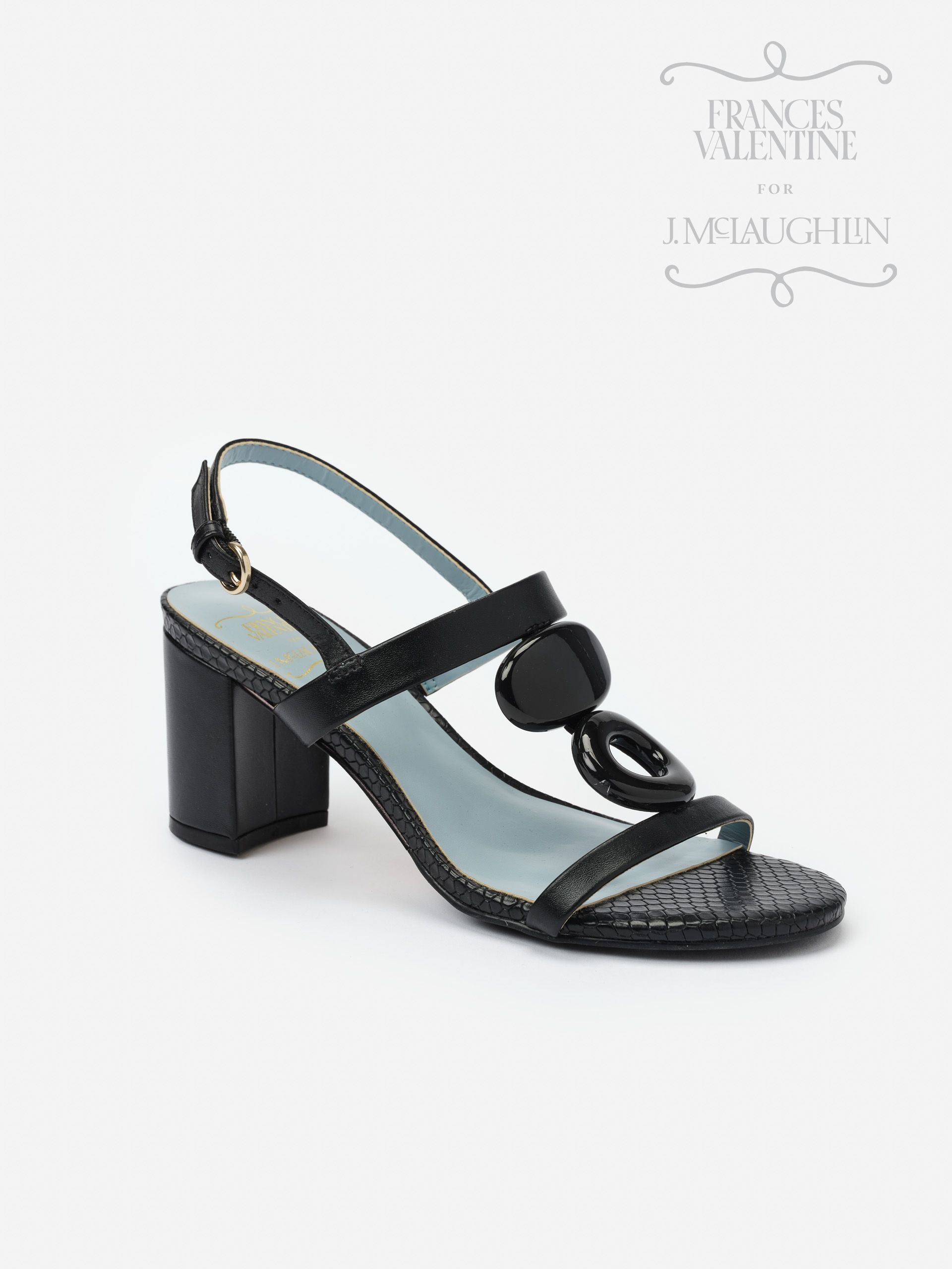 Black Bianca Heels by J.McLaughlin featuring a block heel, textured strap, and glossy decorative accents, embodying effortlessly stylish, enduring designs for a legacy of timeless fashion.