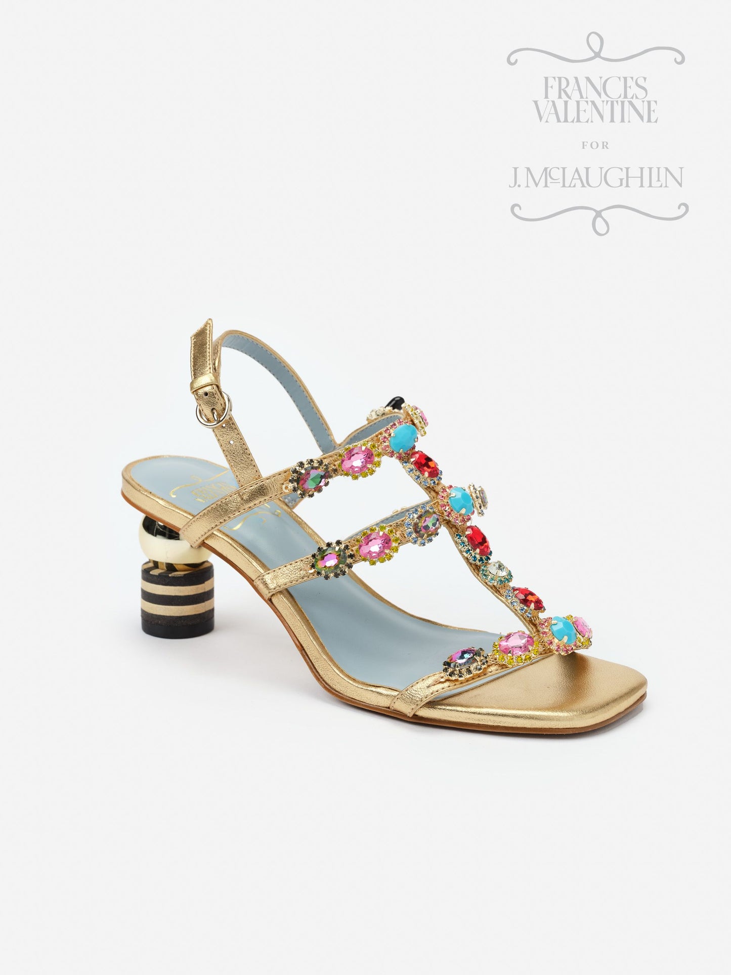 Gold open-toe sandal featuring colorful gem embellishments along the straps and a distinctive striped block heel, embodying effortlessly stylish and enduring designs by J.McLaughlin.