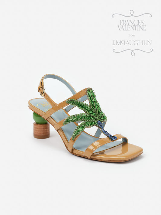 Venus Palm Tree Heels by J.McLaughlin feature a tan patent finish with an embellished green and blue palm tree design on the straps, showcasing effortlessly stylish, enduring designs with innovative fabrics. A destination for defining style. Life, Well-Lived.