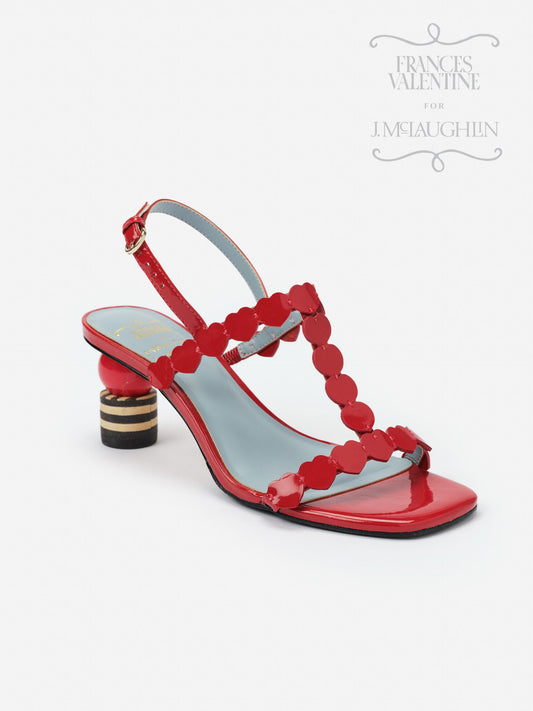 Red patent leather Kiki Heart Heels by J.McLaughlin featuring heart-shaped straps and a unique striped block heel, showcasing effortlessly stylish, enduring designs and innovative fabrics.