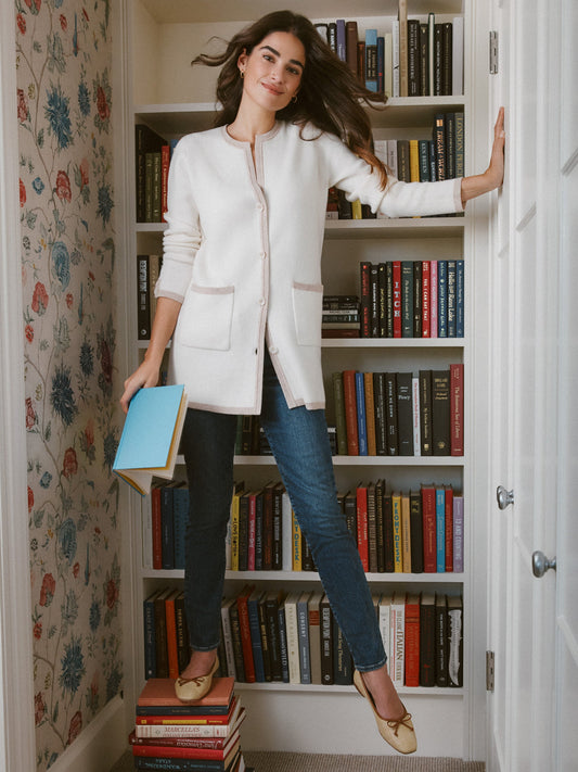 Model wears J.McLaughlin Nan cardigan in off white/oatmeal made with wool/cashmere.