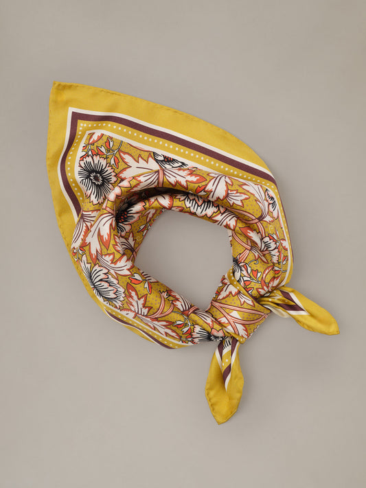 The Eloise Silk Scarf in Belle Epoque Bloom by J.McLaughlin yellow floral silk scarf styled in a loop with trailing ends