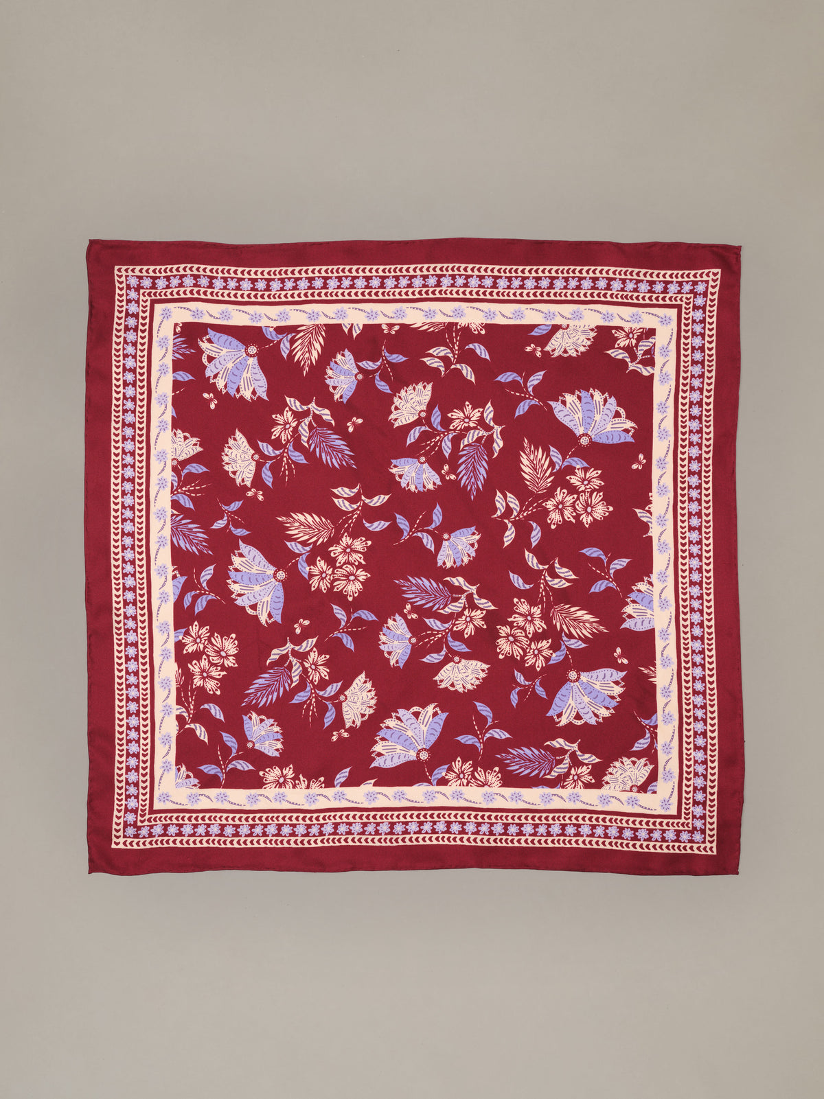 The Eloise Silk Scarf in Hastings Garden by J.McLaughlin shown as a red 100 percent silk scarf with a delicate floral print and decorative border
