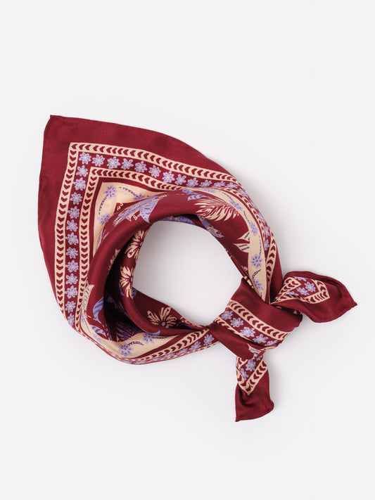 The Eloise Silk Scarf in Hastings Garden by J.McLaughlin, featuring a rich burgundy base with delicate floral and geometric patterns, showcasing timeless elegance and craftsmanship.