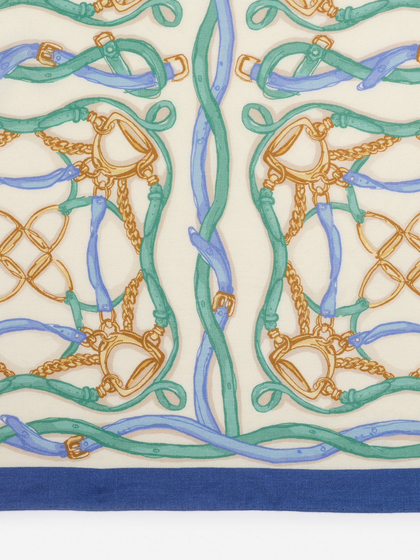Close-up of J.McLaughlin’s Sarita Scarf in Riding Lessons Corner featuring a delicate pattern of intertwined leather straps and chains in soft blue and green tones on cream, embodying effortlessly stylish, enduring designs with a legacy of timeless fashion at a destination for defining style. Life, Well-Lived.