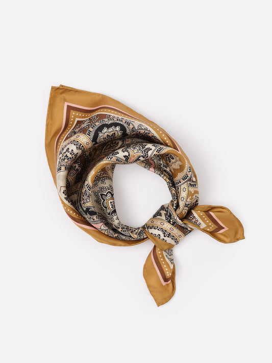 The Eloise Silk Scarf in Far Paisley by J.McLaughlin features a classic paisley pattern in warm tones, crafted from luxurious silk for an effortlessly stylish accessory.