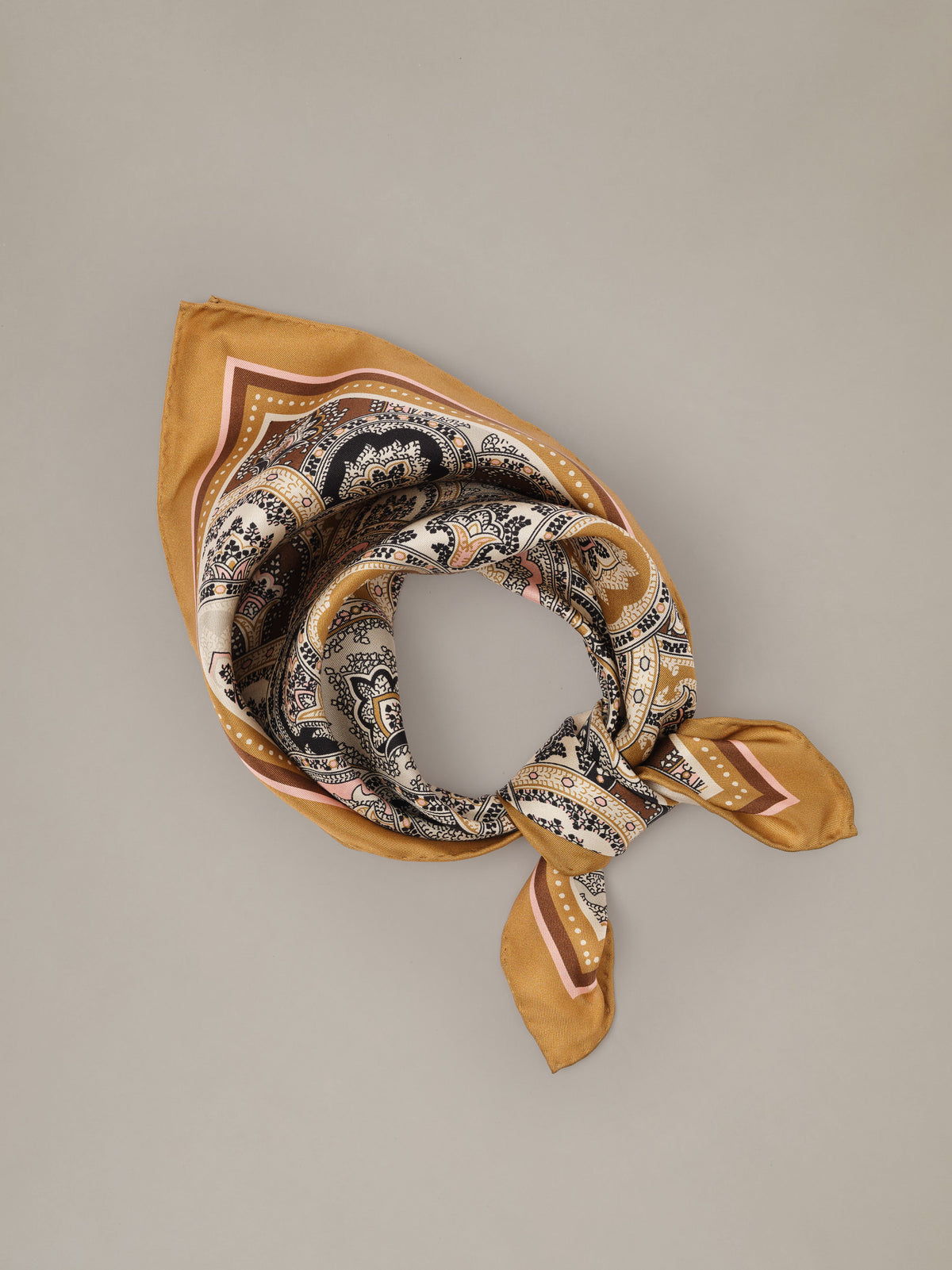 The Eloise Silk Scarf in Far Paisley by J.McLaughlin featuring an ornate paisley print in warm gold and neutral tones