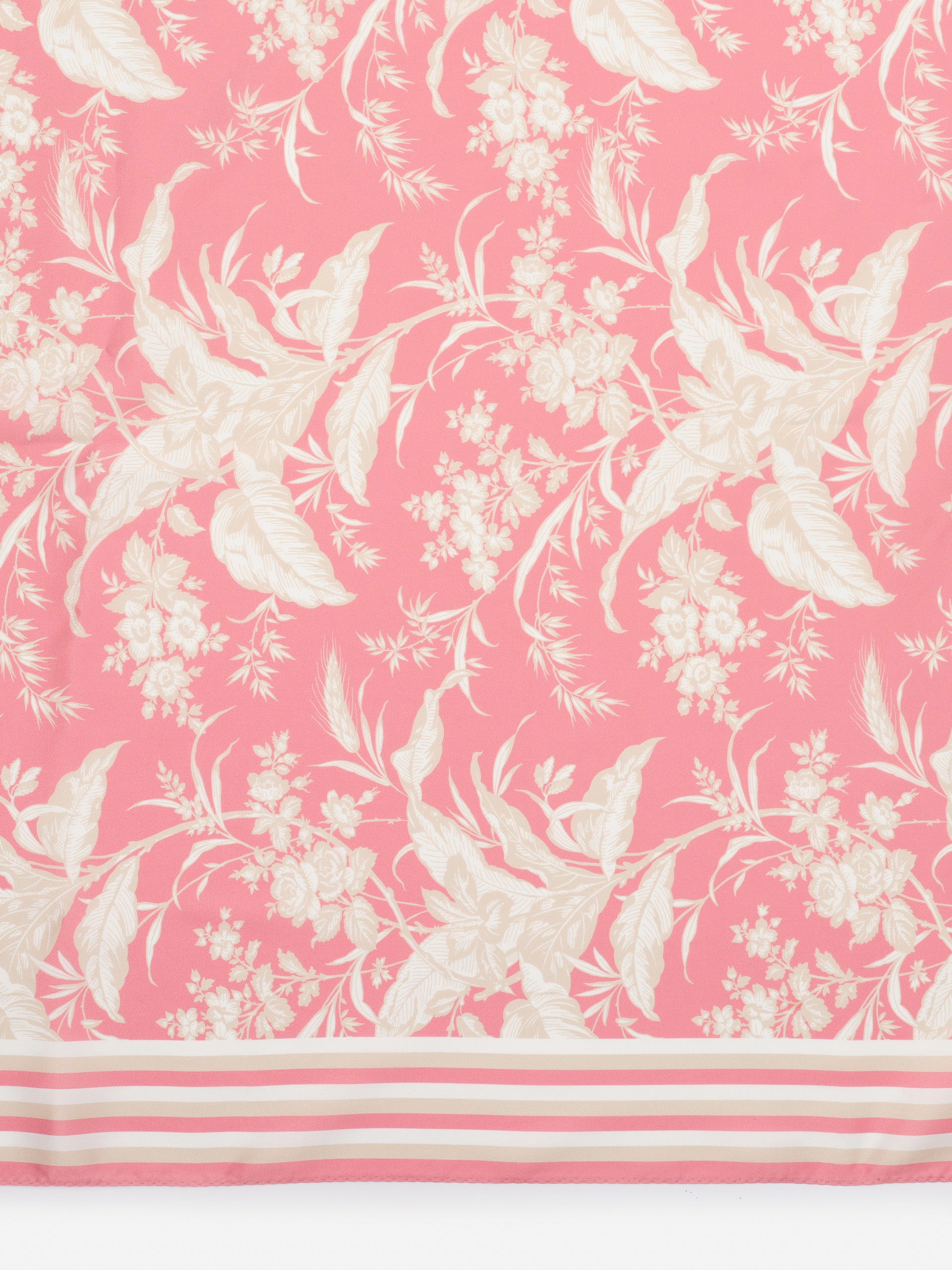 The Magic Scarf in Giardino Toile Border by J.McLaughlin features a delicate floral pattern in soft cream tones on a pink background, embodying effortlessly stylish, enduring designs. A destination for defining style. Life, Well-Lived.