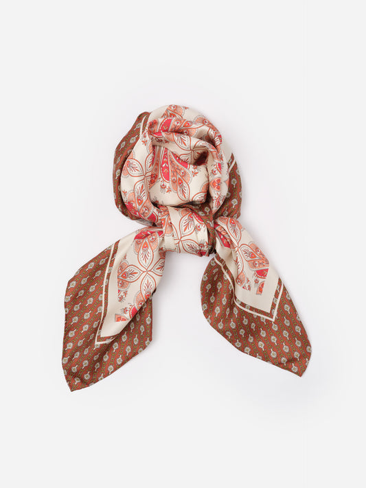 The Grace Silk Scarf in Neo Radiant Square by J.McLaughlin features an elegant silk design with warm earthy tones and intricate patterns, perfect for elevating bags or outfits.
