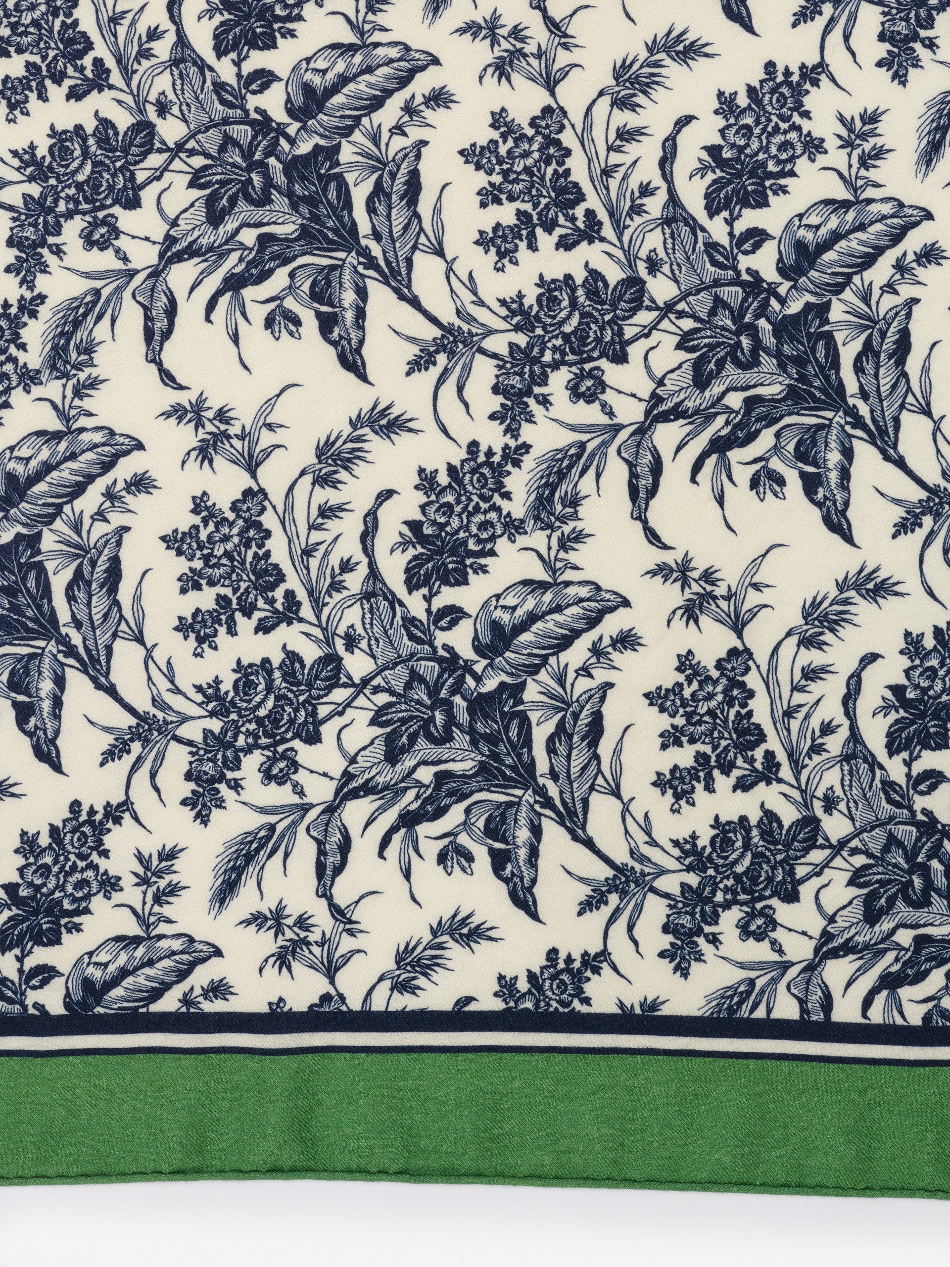 Intricately detailed blue floral pattern on cream fabric with green border of the Sarita Scarf in Giardino Toile Corner by J.McLaughlin, showcasing effortlessly stylish scarves with enduring designs.