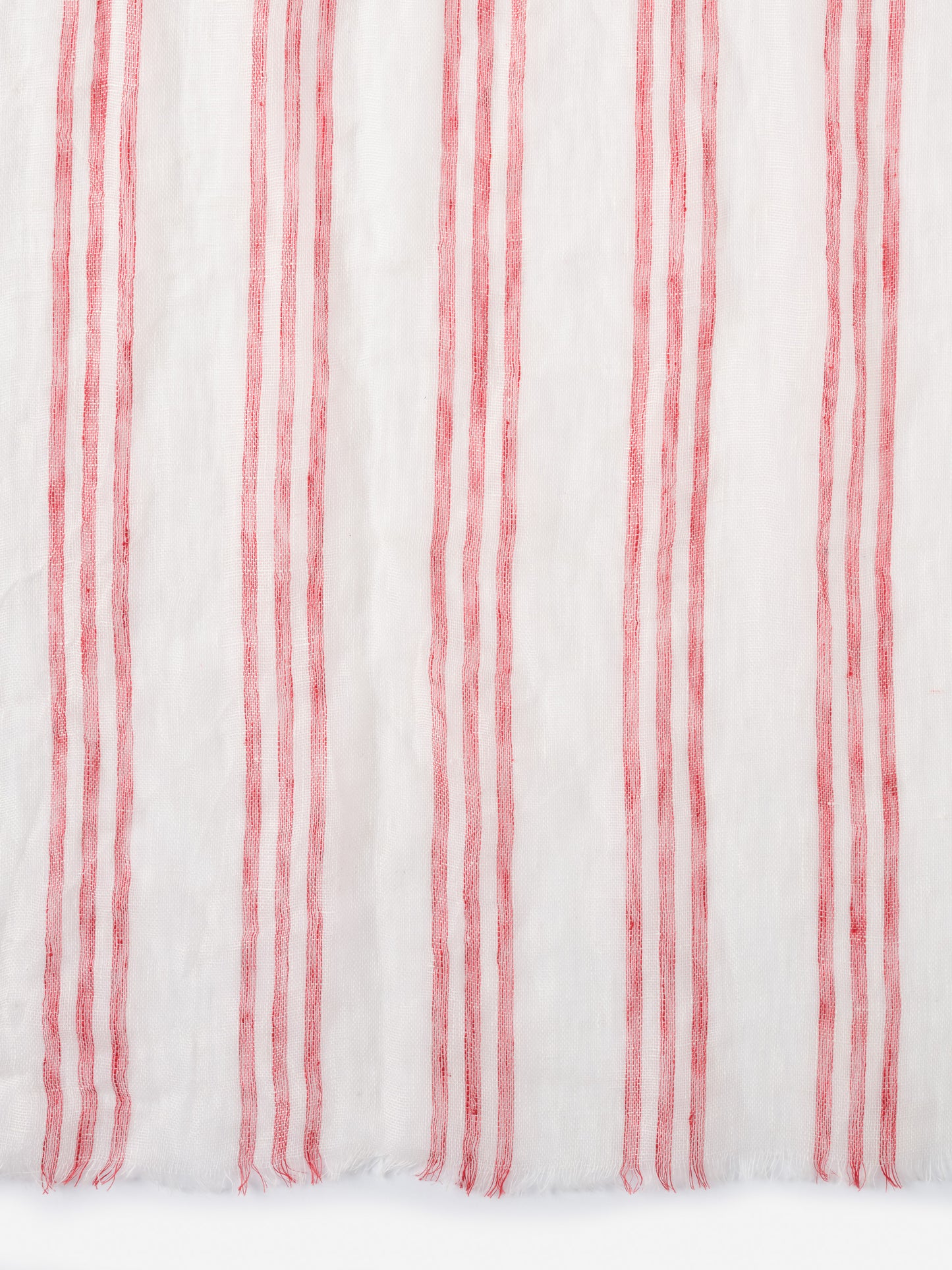 Close-up of the Tessa Linen Scarf in Stripe by J.McLaughlin featuring lightweight linen fabric with vertical red stripes, embodying effortlessly stylish, enduring designs and innovative fabrics.